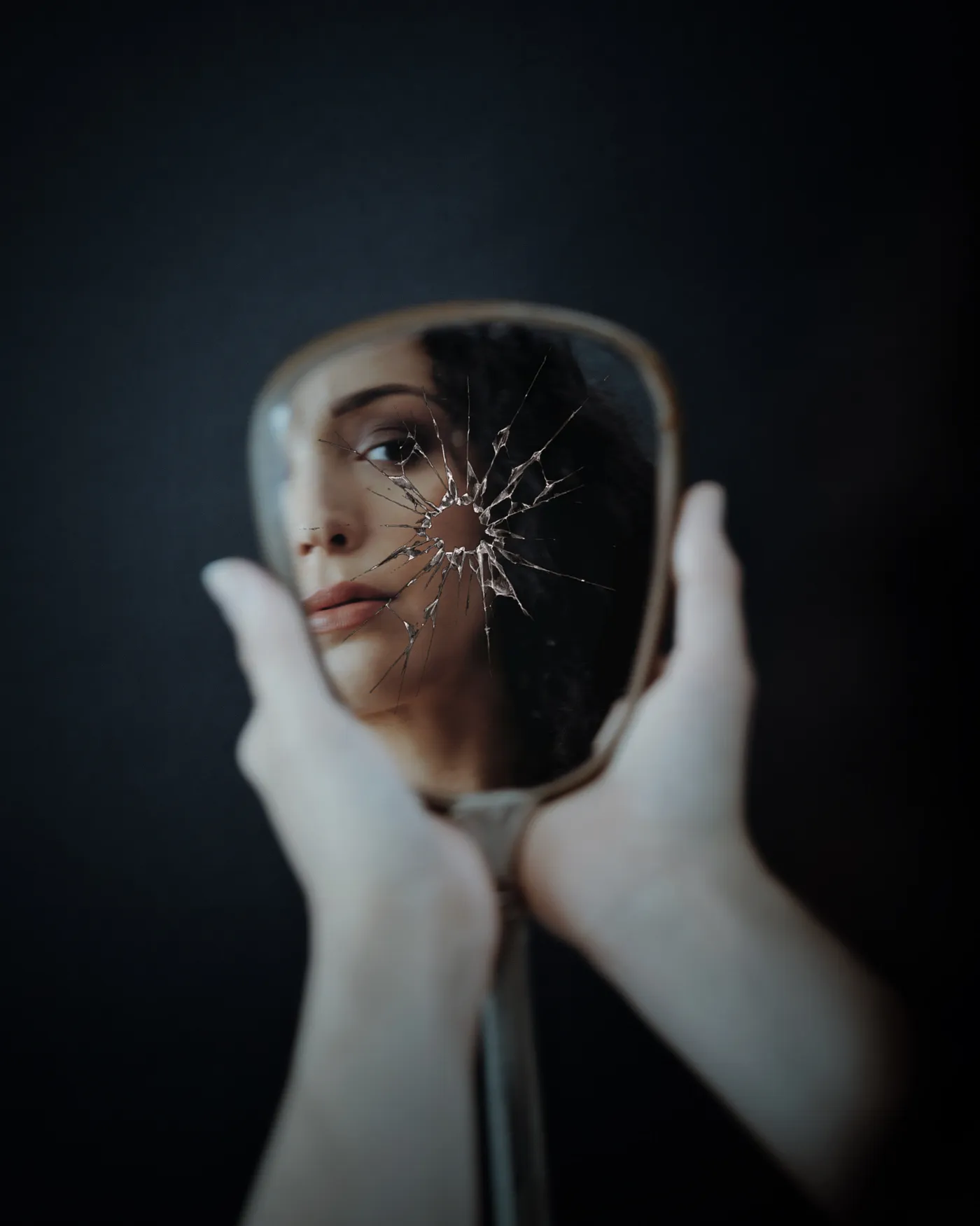 Photo by Trevor Lawrence: https://www.pexels.com/photo/woman-looking-in-broken-mirror-13687593/