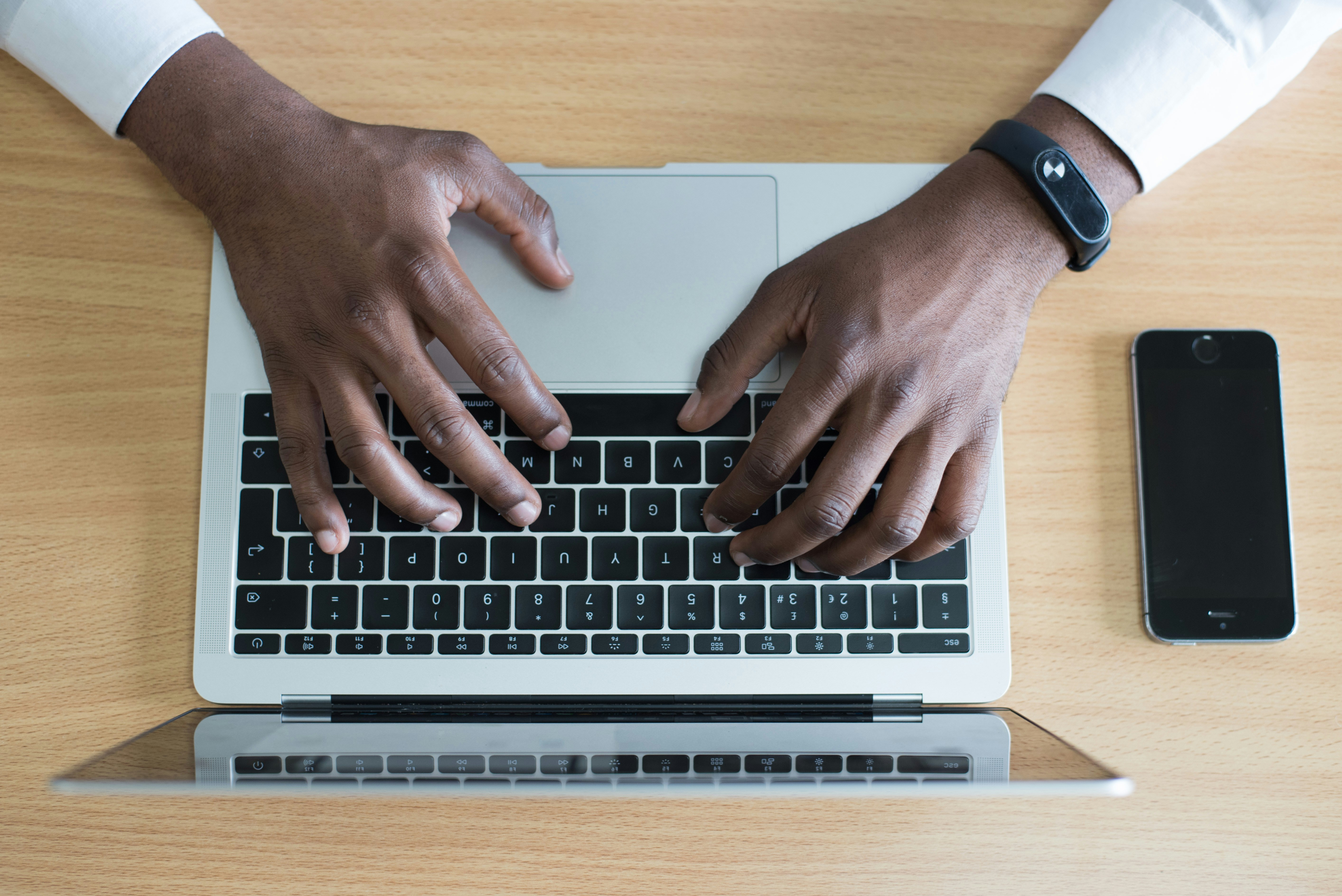 man typing on laptop - Literature Review Tools