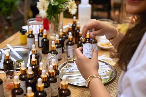 A person pouring essential oils into a bottle during a perfume-making session, emphasizing the detailed and artistic process involved in creating a unique scent in Istanbul.