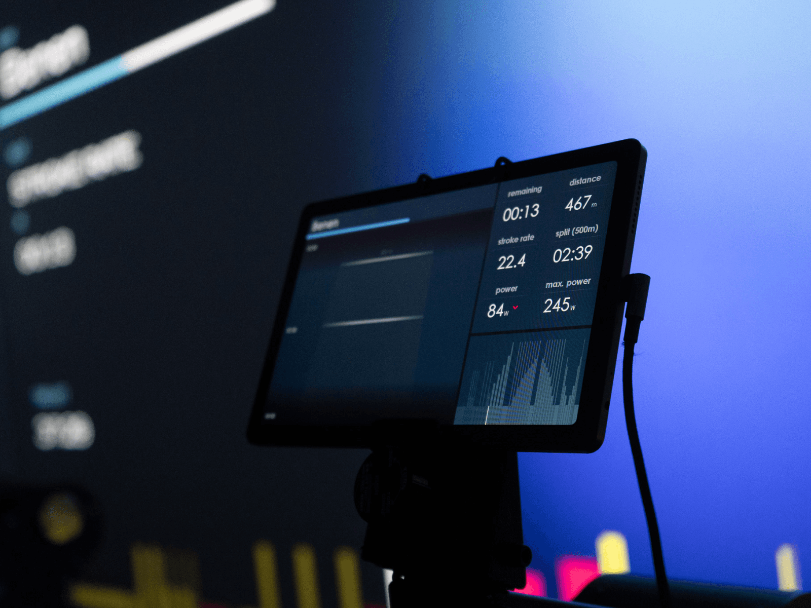 tablet mounted on a rowing machine displaying the individual performance data of the athelte.