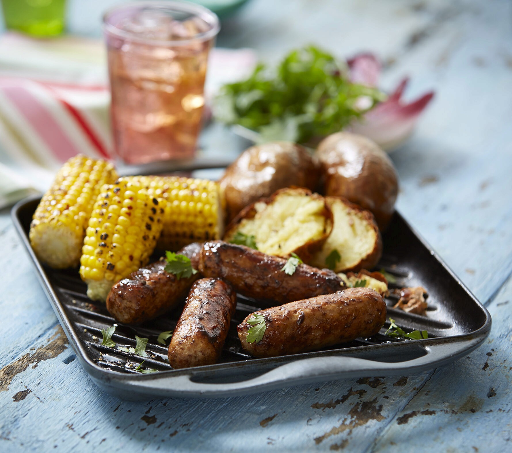 A plate of barbecued sausages, potatotoes and corn on the cob featuring fresh produce from Finnebrogue