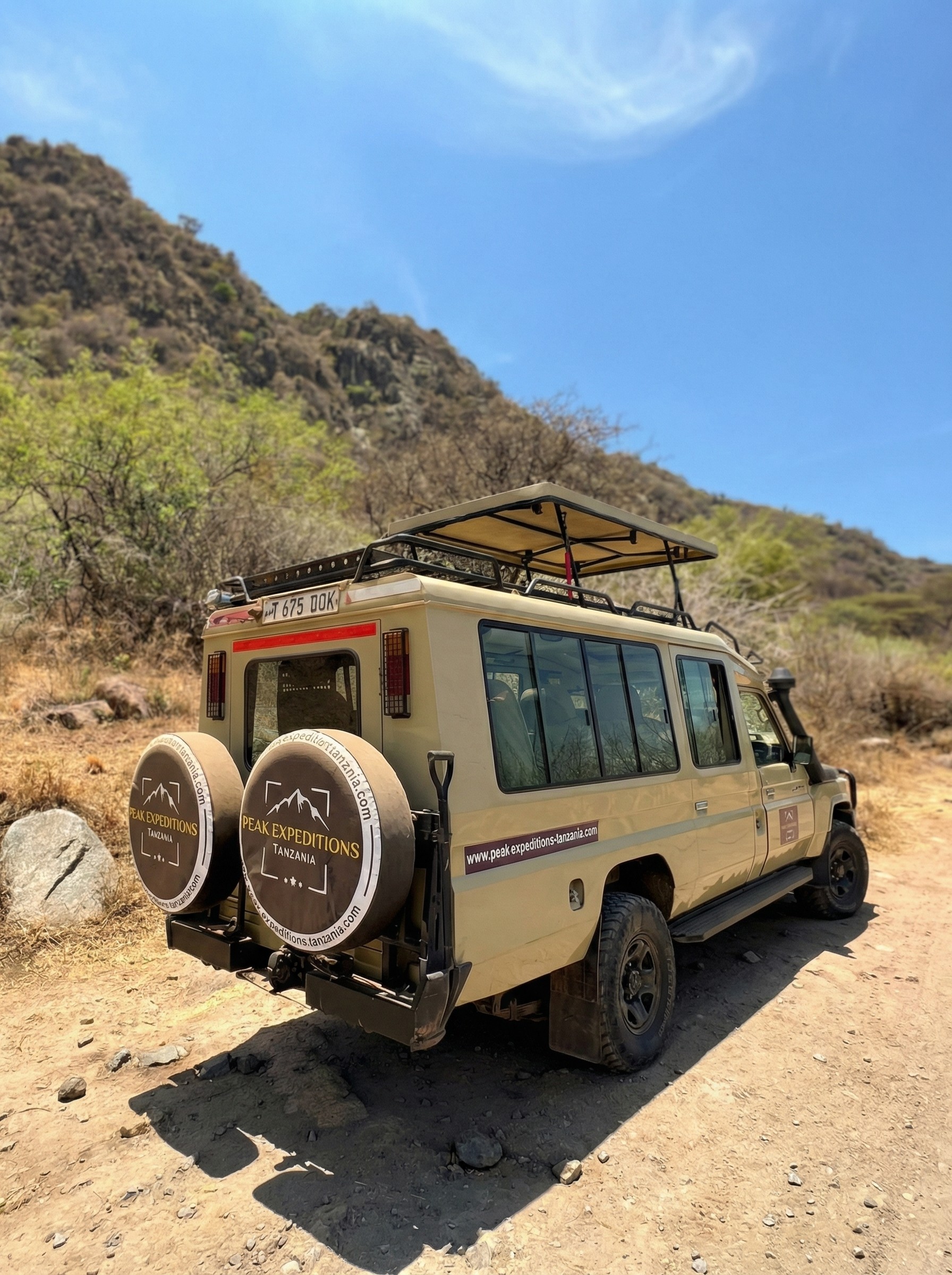 Camel caravan crossing vast golden dunes in AlUla, symbolizing traditional desert journeys.
