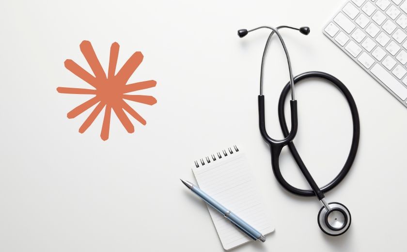 Scoped Work - Three people sit around a table discussing work, with laptops and monitors in a bright, modern office space.