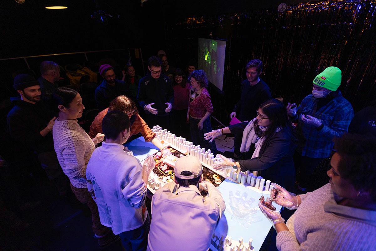 Audience members help destroy the miniature city.