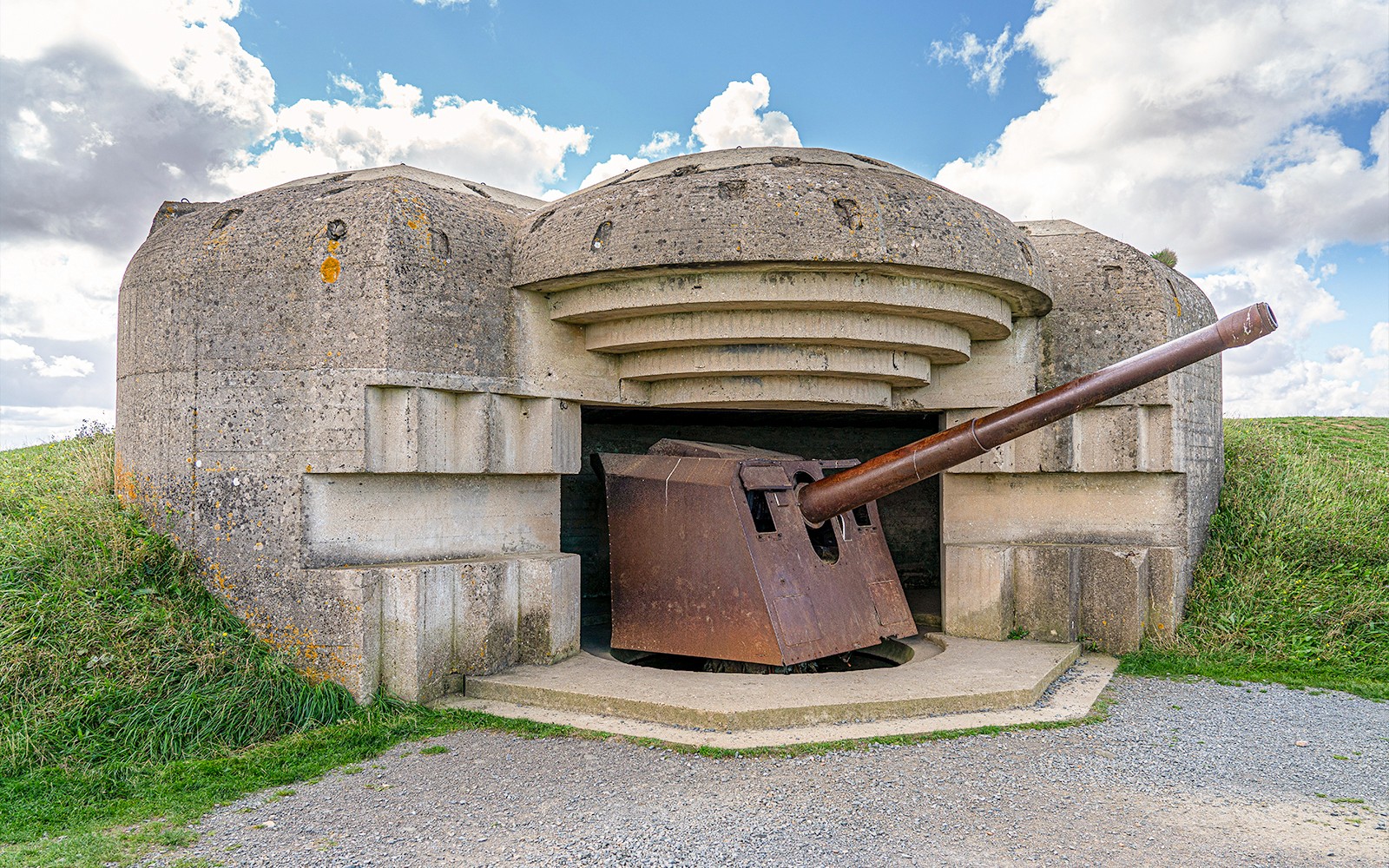 World War II bunker with artillery gun at Normandy D-Day landing site.