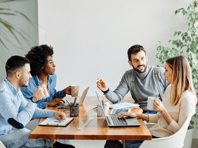 Team meeting with colleagues collaborating on a leadership development plan.