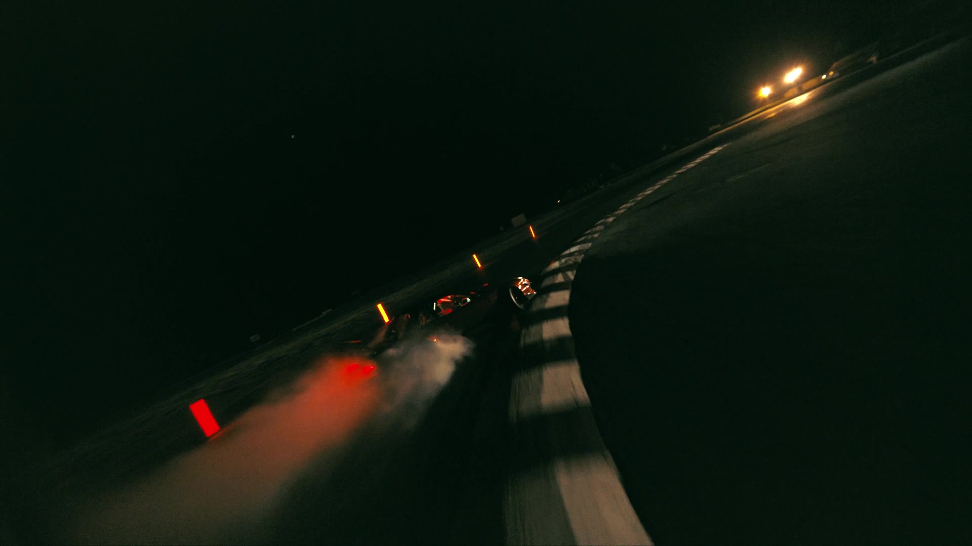 Night drift run on illuminated racetrack, rear lights and tire smoke cutting through darkness — Spring Show
