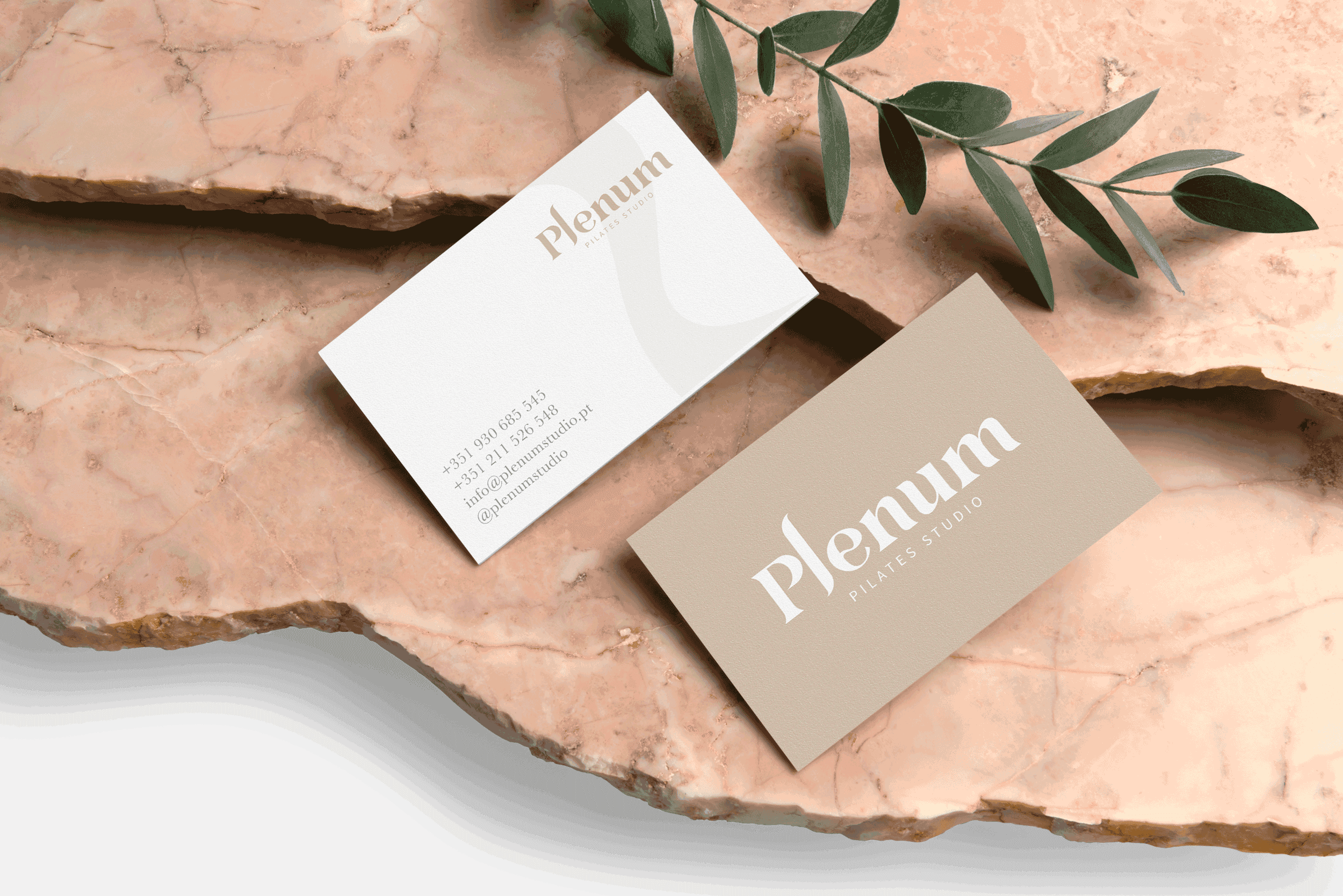 Minimalist business card design created by No Harm Design for Plenum Pilates Studio, featuring elegant typography and neutral tones photographed on natural stone.