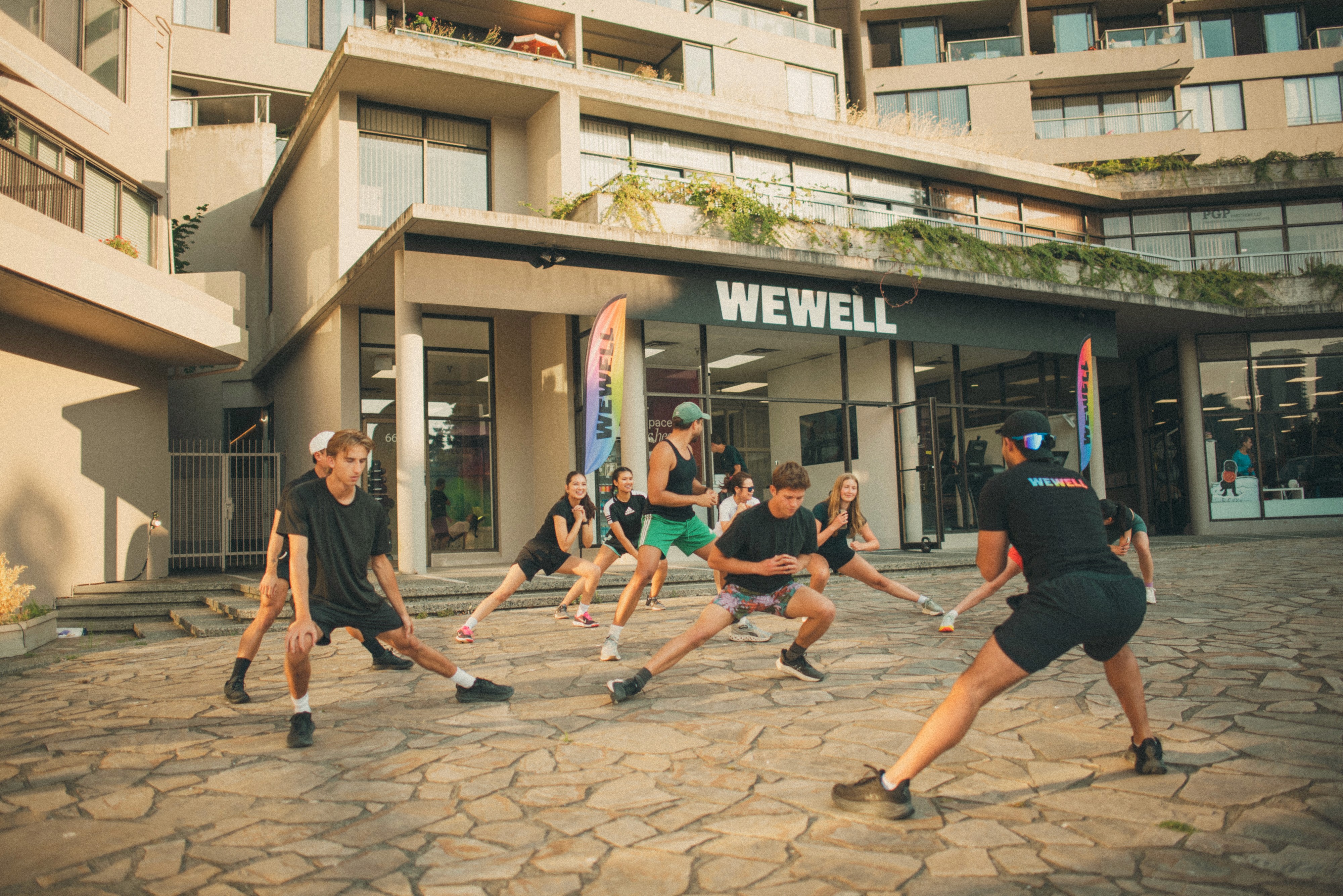 Athlete in a black sports bra and shorts running outdoors under a clear blue sky, with bold red text reading "pyra." across the image.