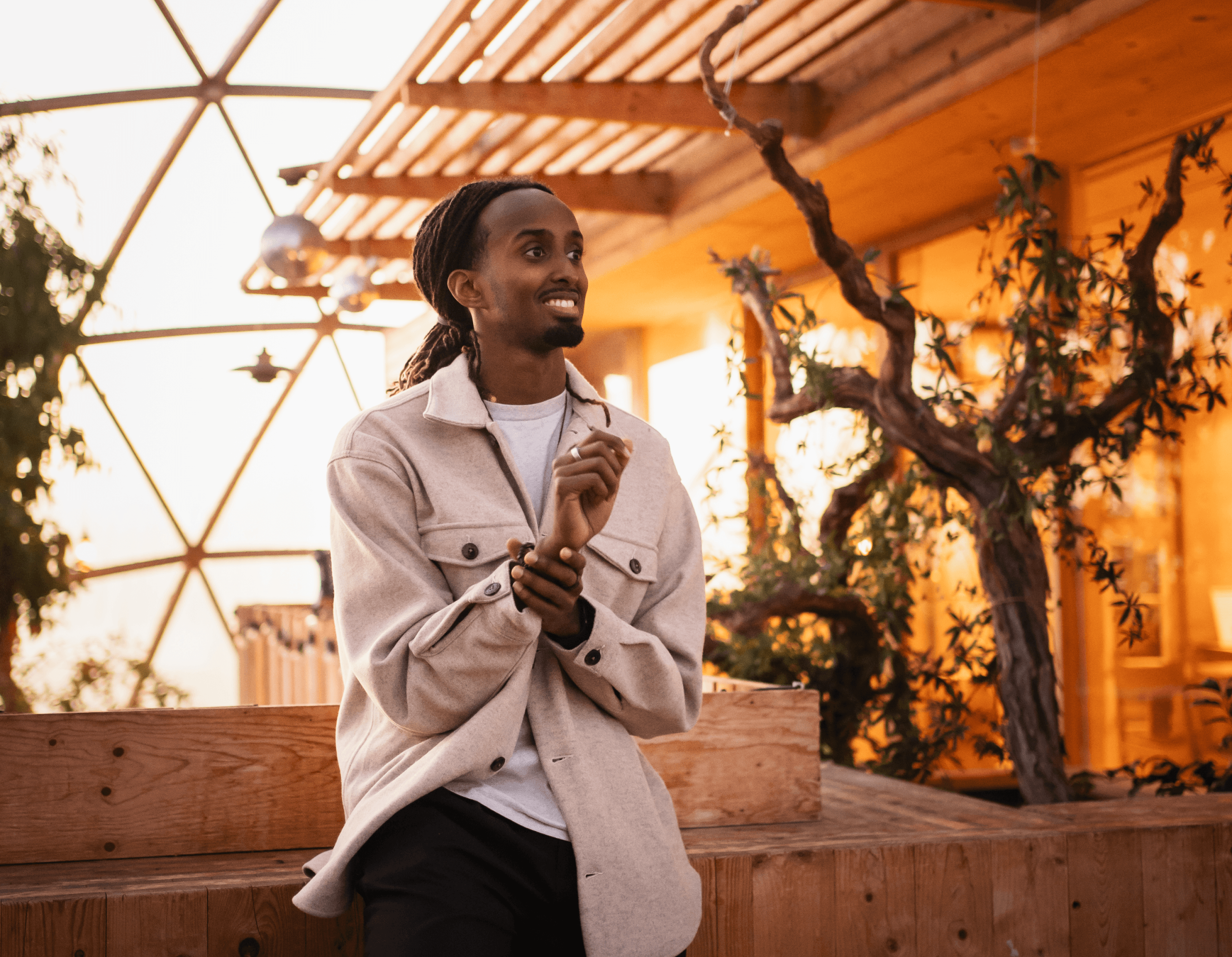 a woman in a red cape standing in the woods