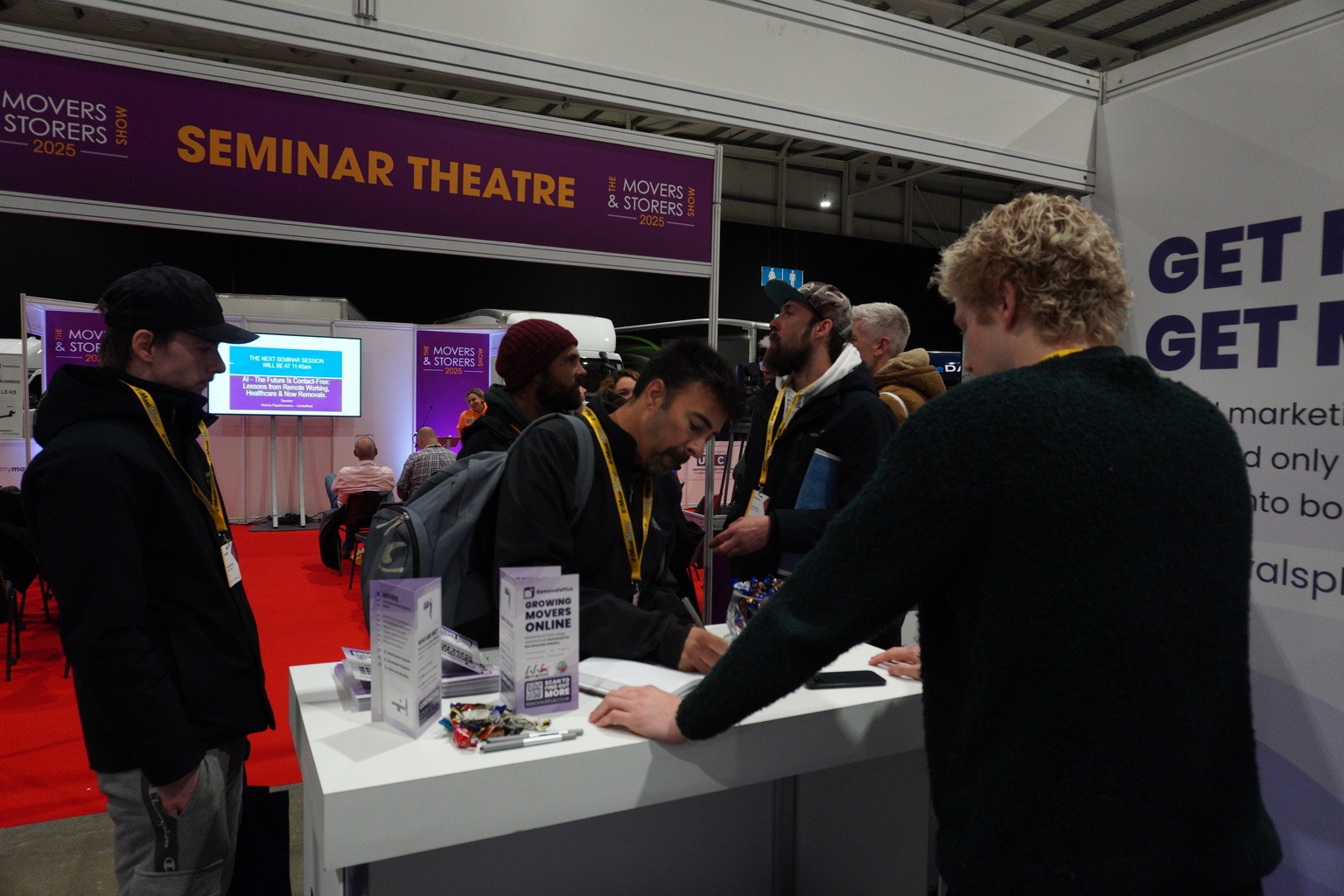 Black and white portrait of a smiling person with curly hair