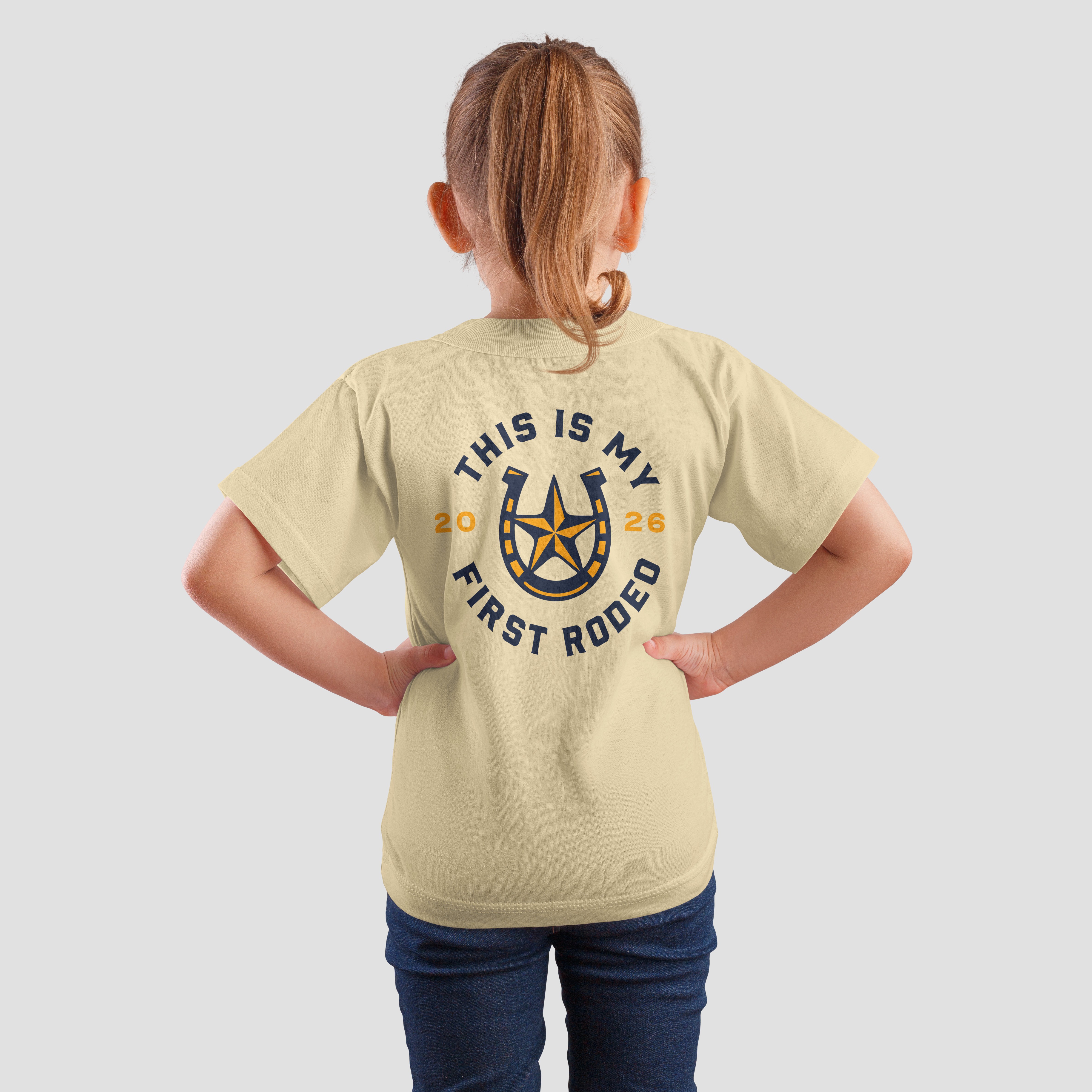 mockup of young girl wearing "This is my first rodeo" speculative shirt design for RCR