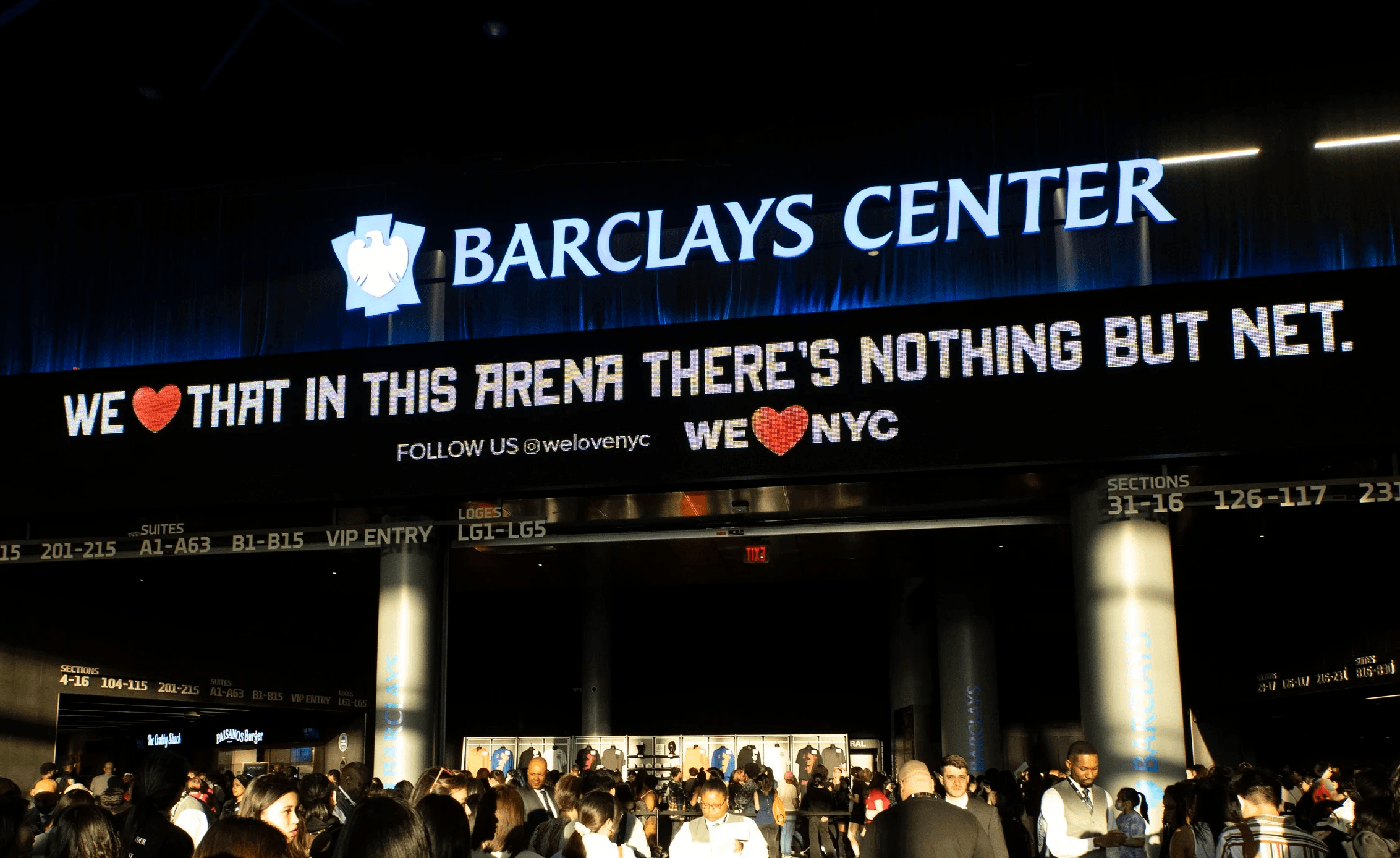 Outdoor digital signage at the entrance to the Barclays Center that reads "We love that in this areana there's nothing but net" and the We Love NYC logo