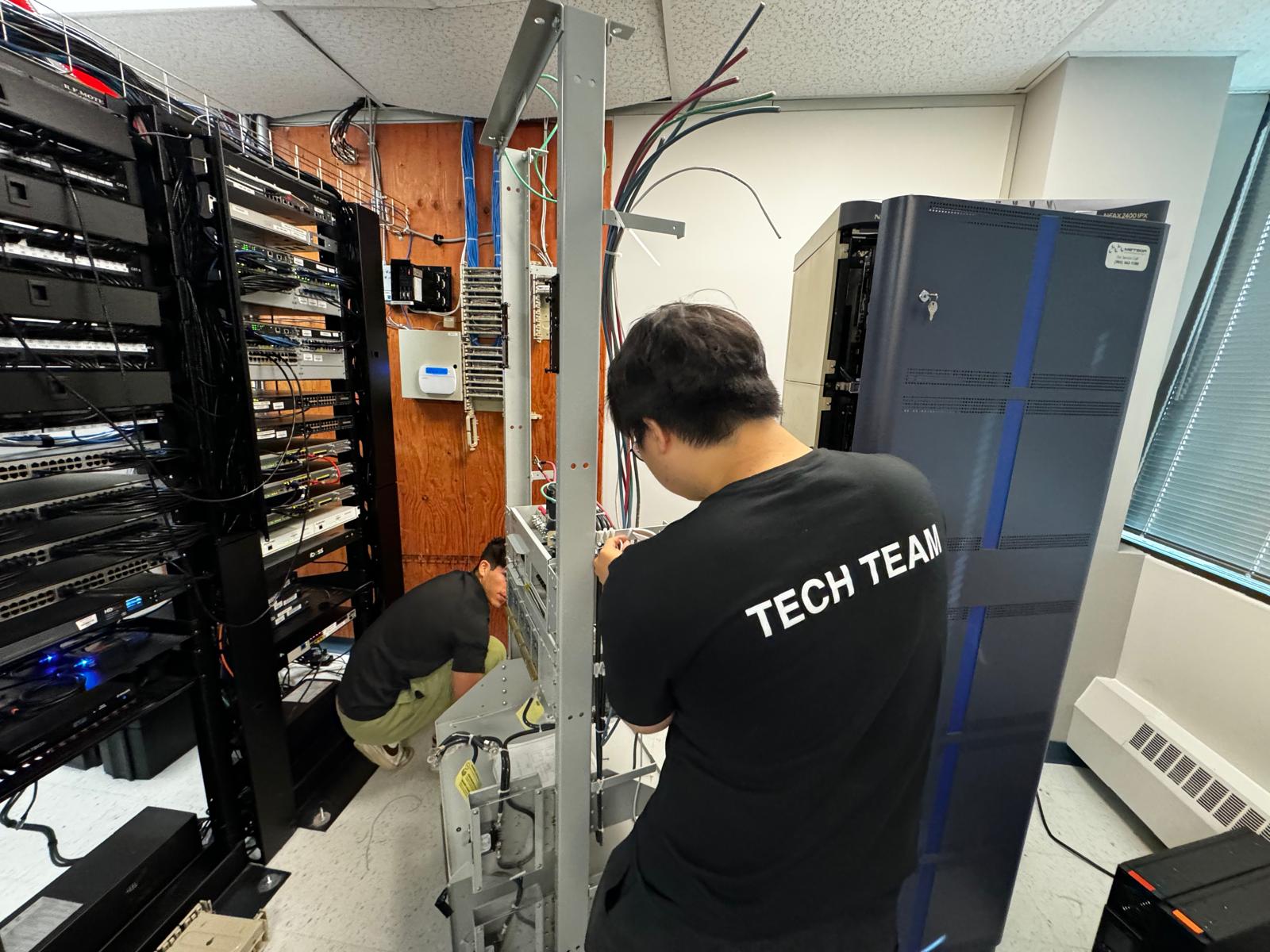Server room decommission and removal with technician disconnecting network racks and structured cabling