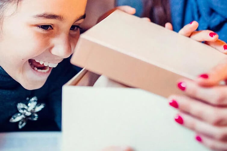 Smiling child opening a gift box
