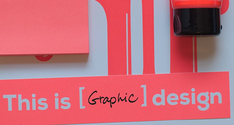 A red and grey part of a 3d art work with the text: This is Graphic design.