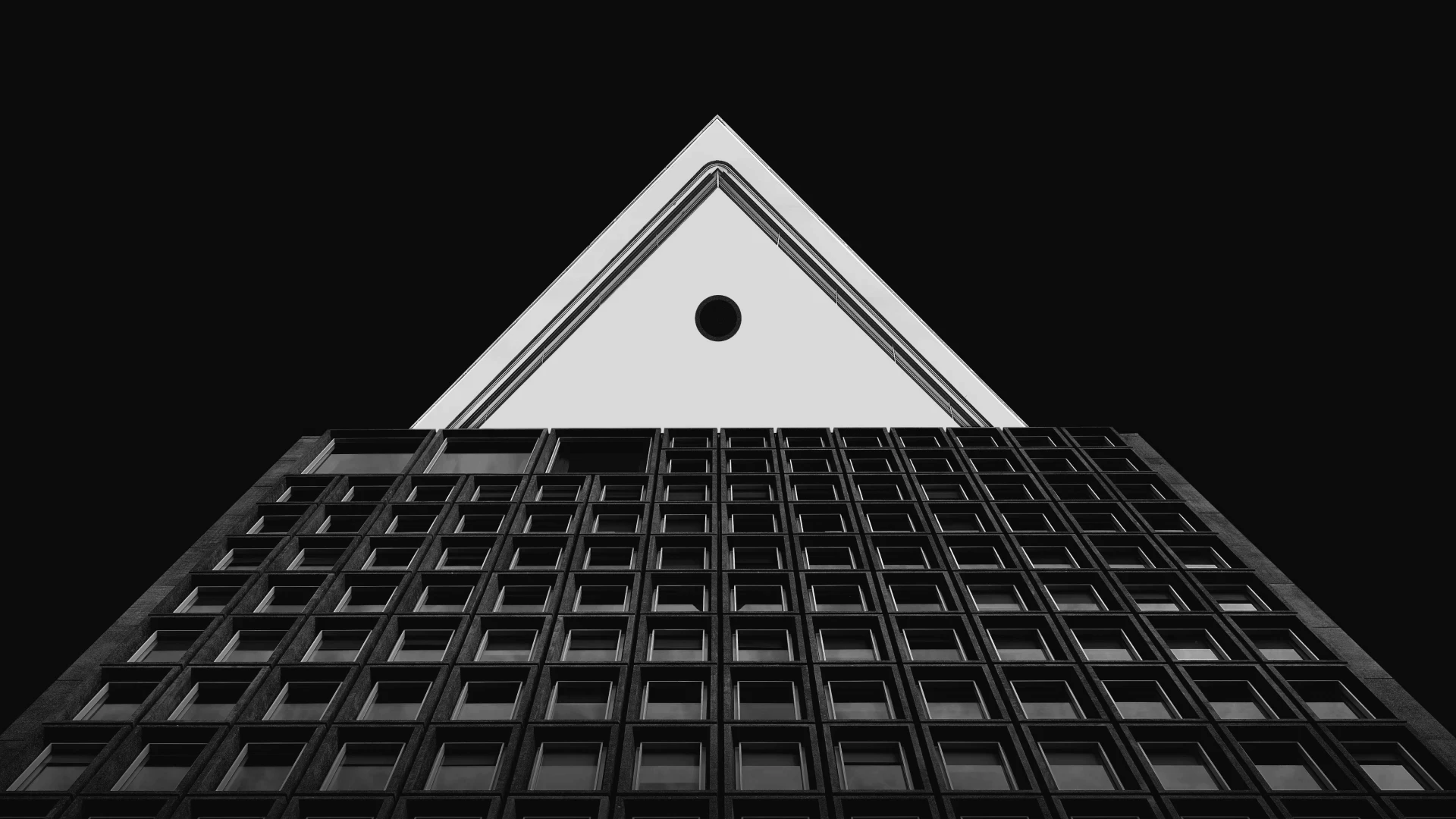 Triangular structure above a grid of windows