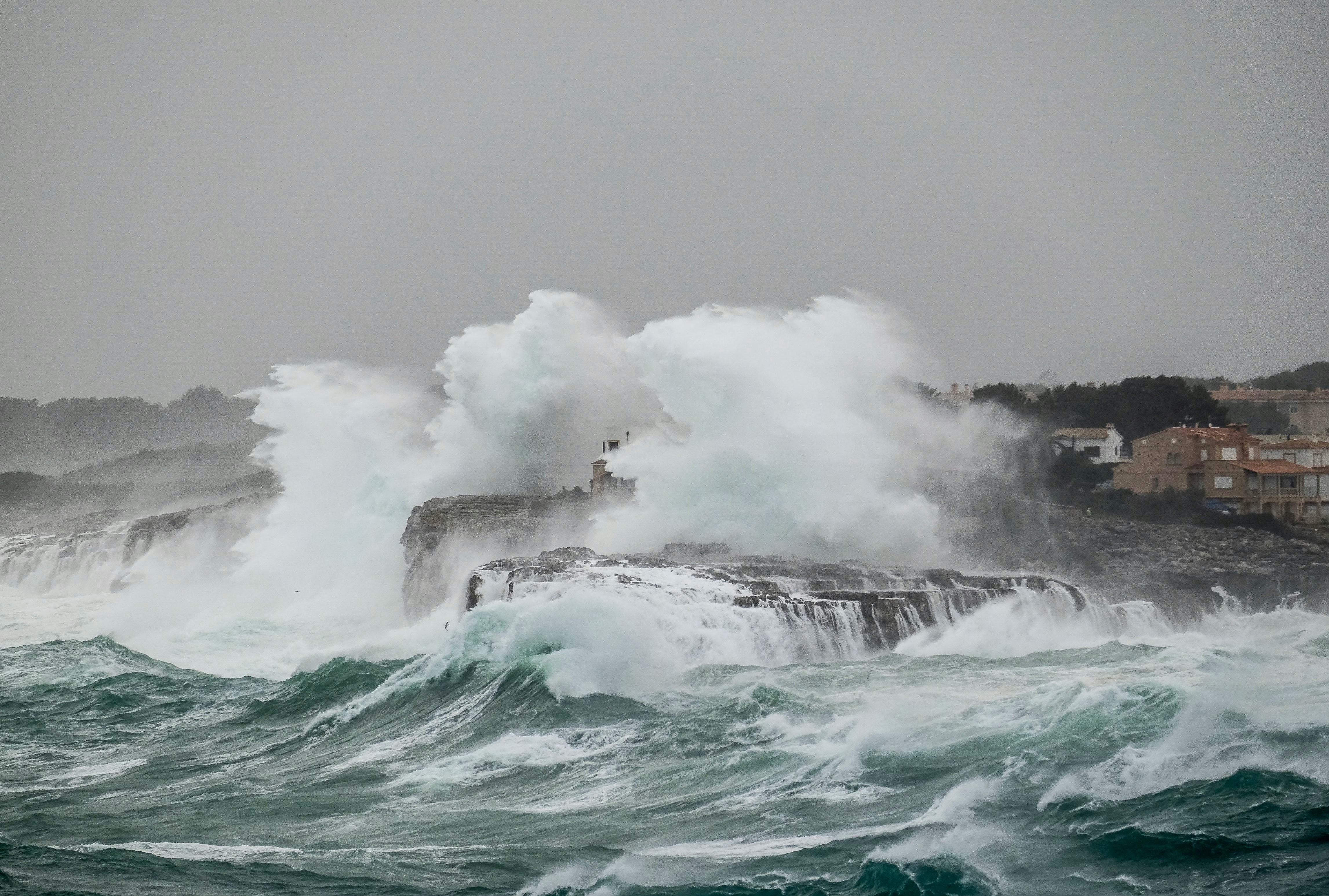 Extreme weather with sea crashing over rocks
