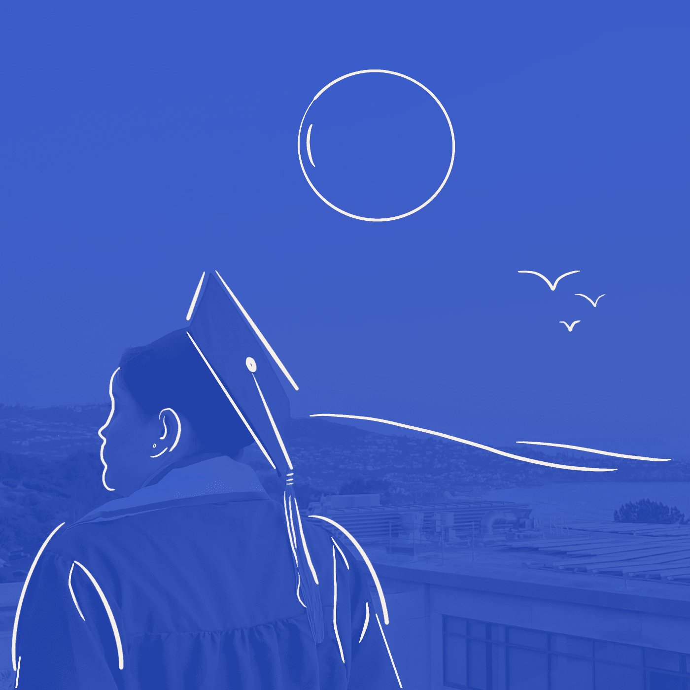 A college graduate standing on a hill with their back to the camera.