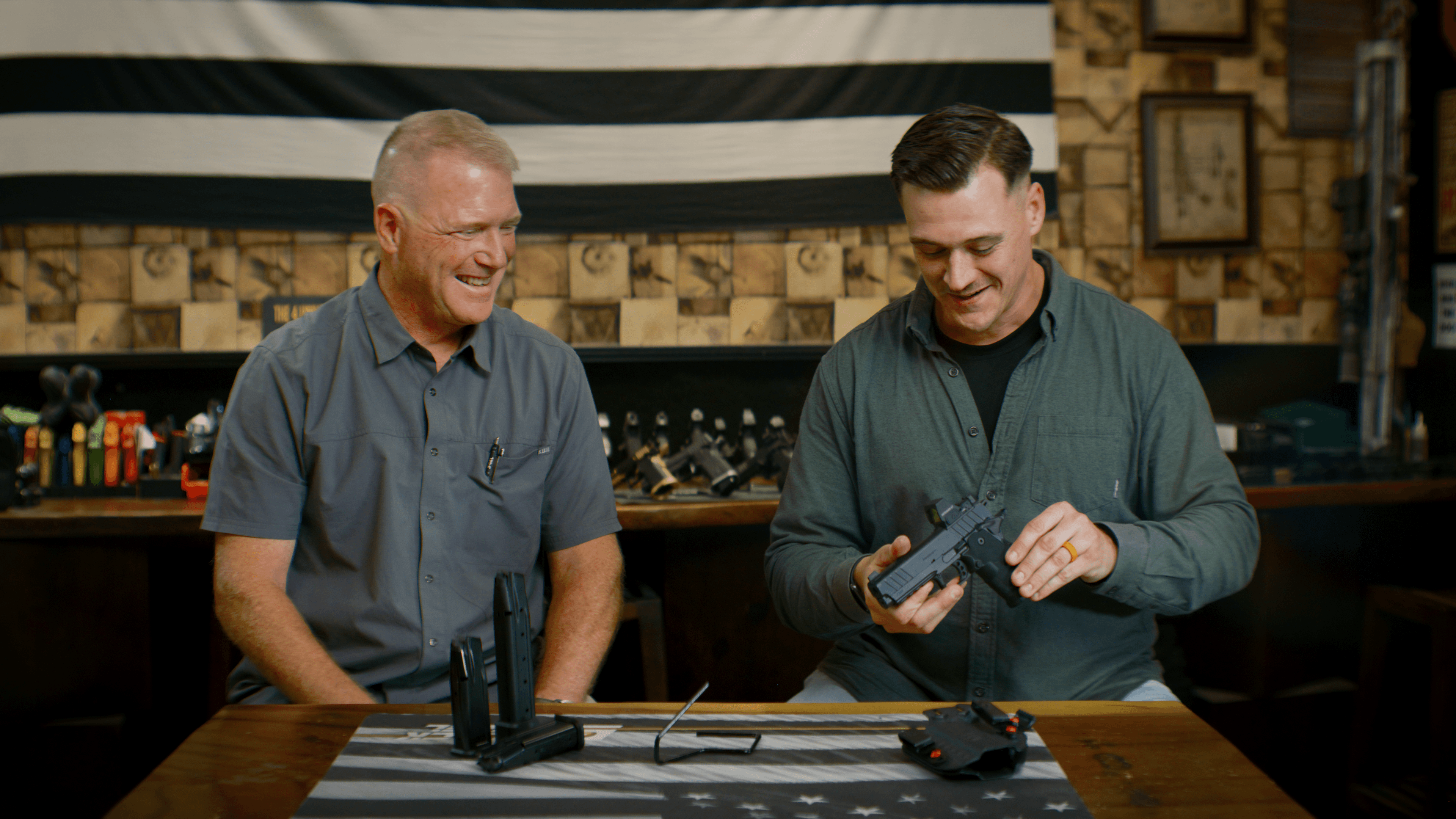Team collaborating in a modern office with computers and laptops on a shared desk.