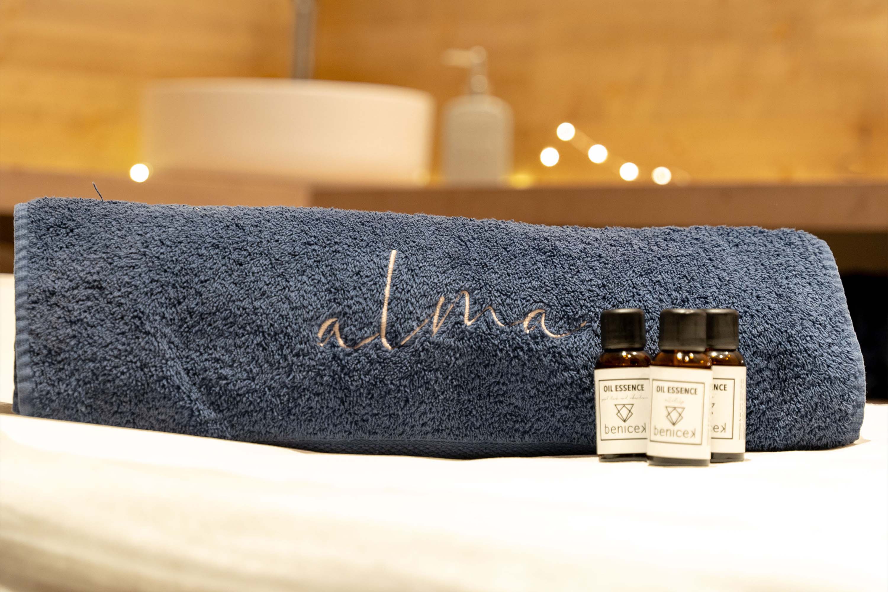 Close-up of lush, dark green leaves, some glossy and wet, against a muted background.