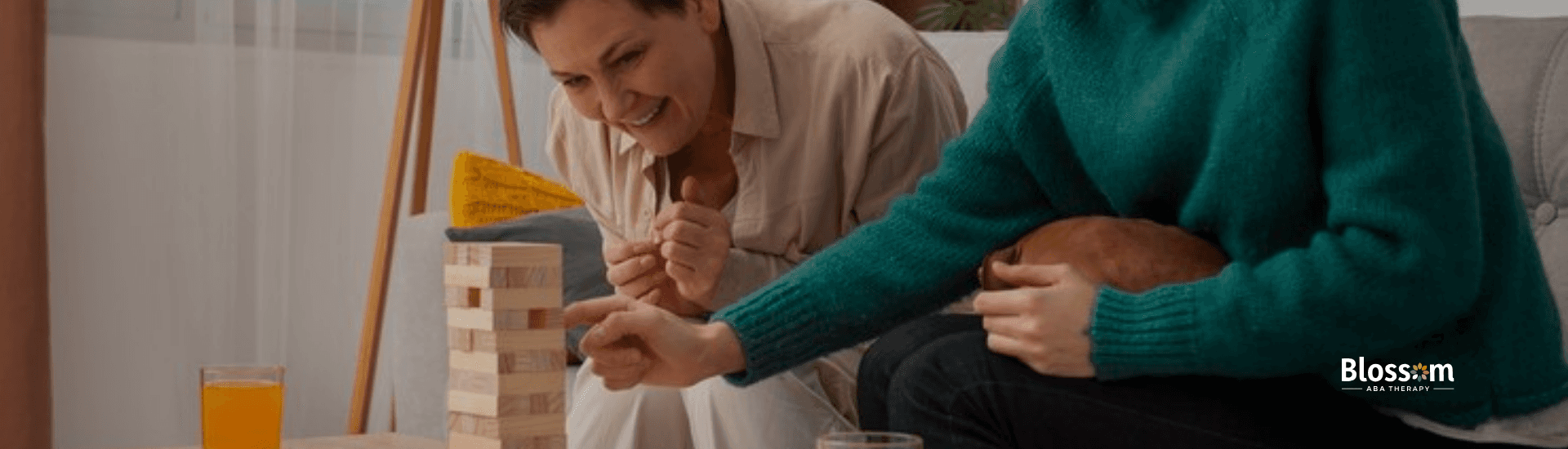 Two autistic adults painting a stool chair