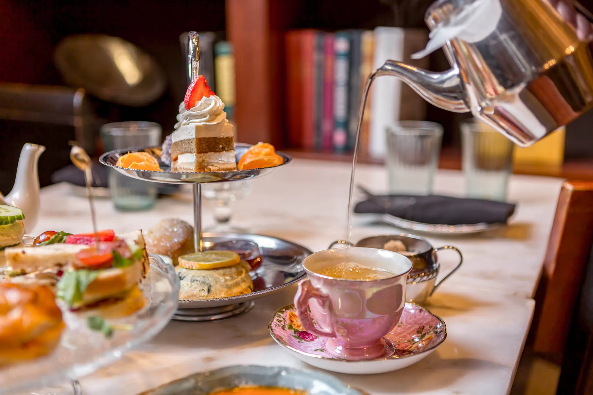 Afternoon tea tier stand and tea being poured at Asterisk Supper Club