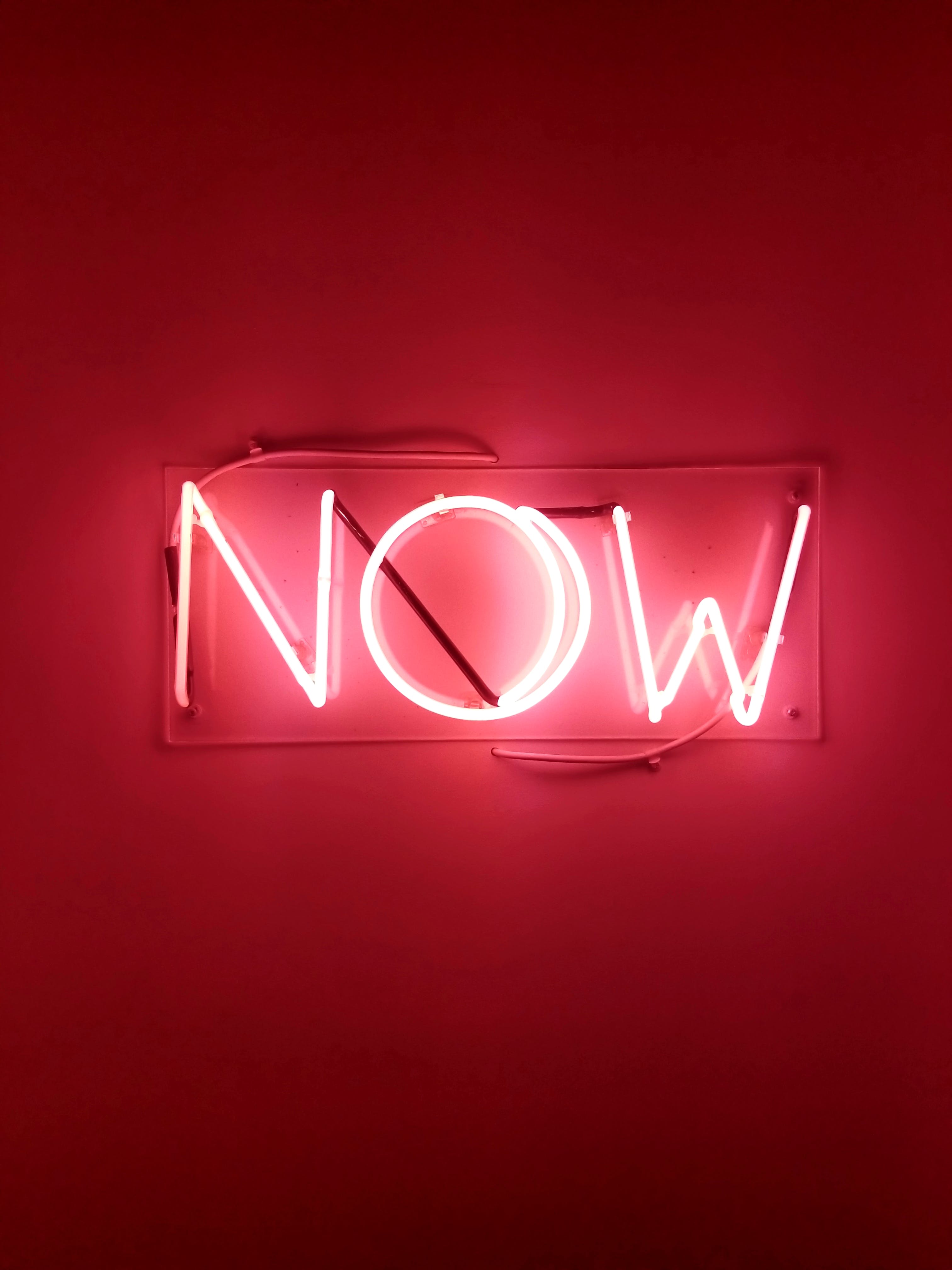 neon sign spelling the word "now"