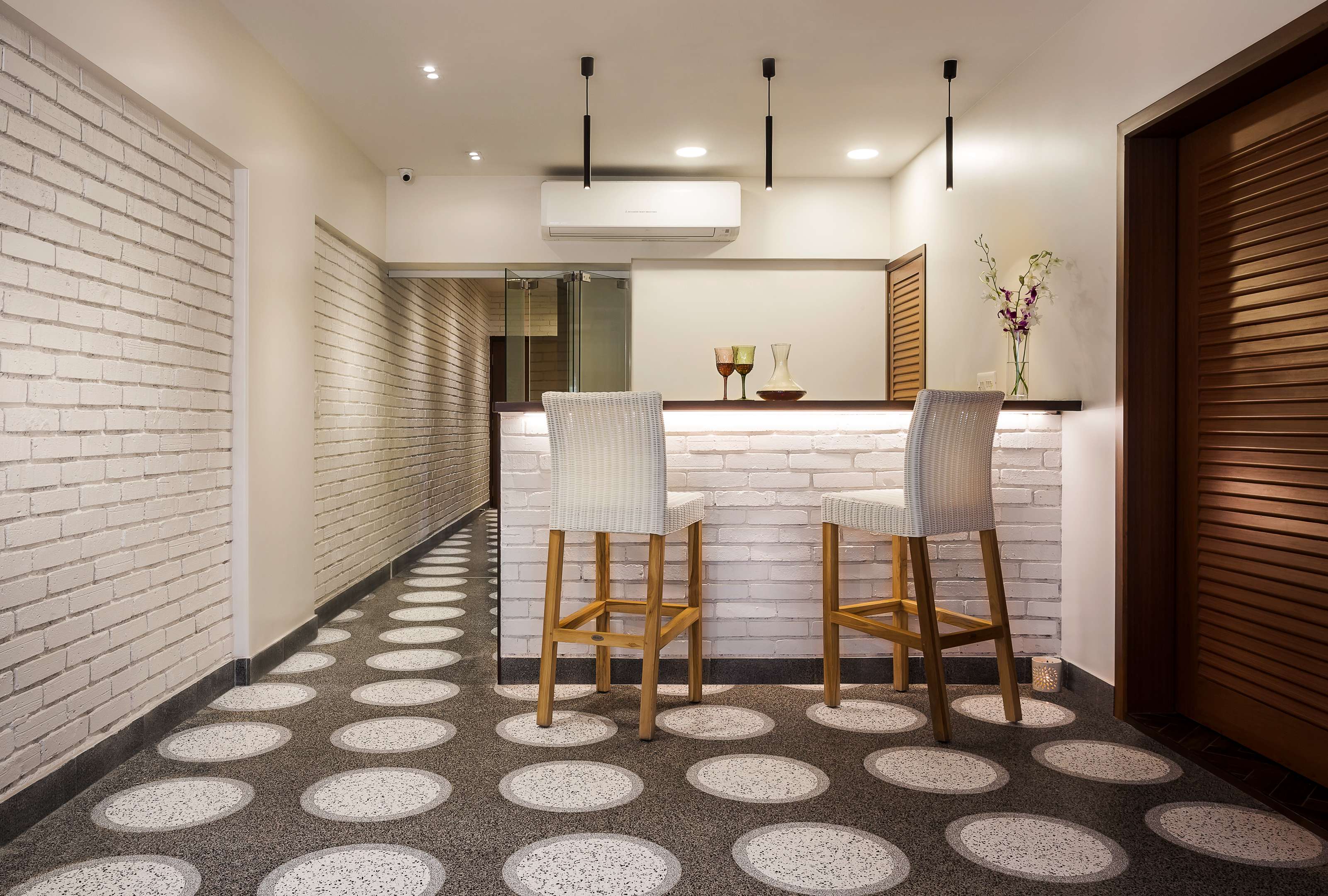 Living room with wooden shelving partition and patterned circular flooring