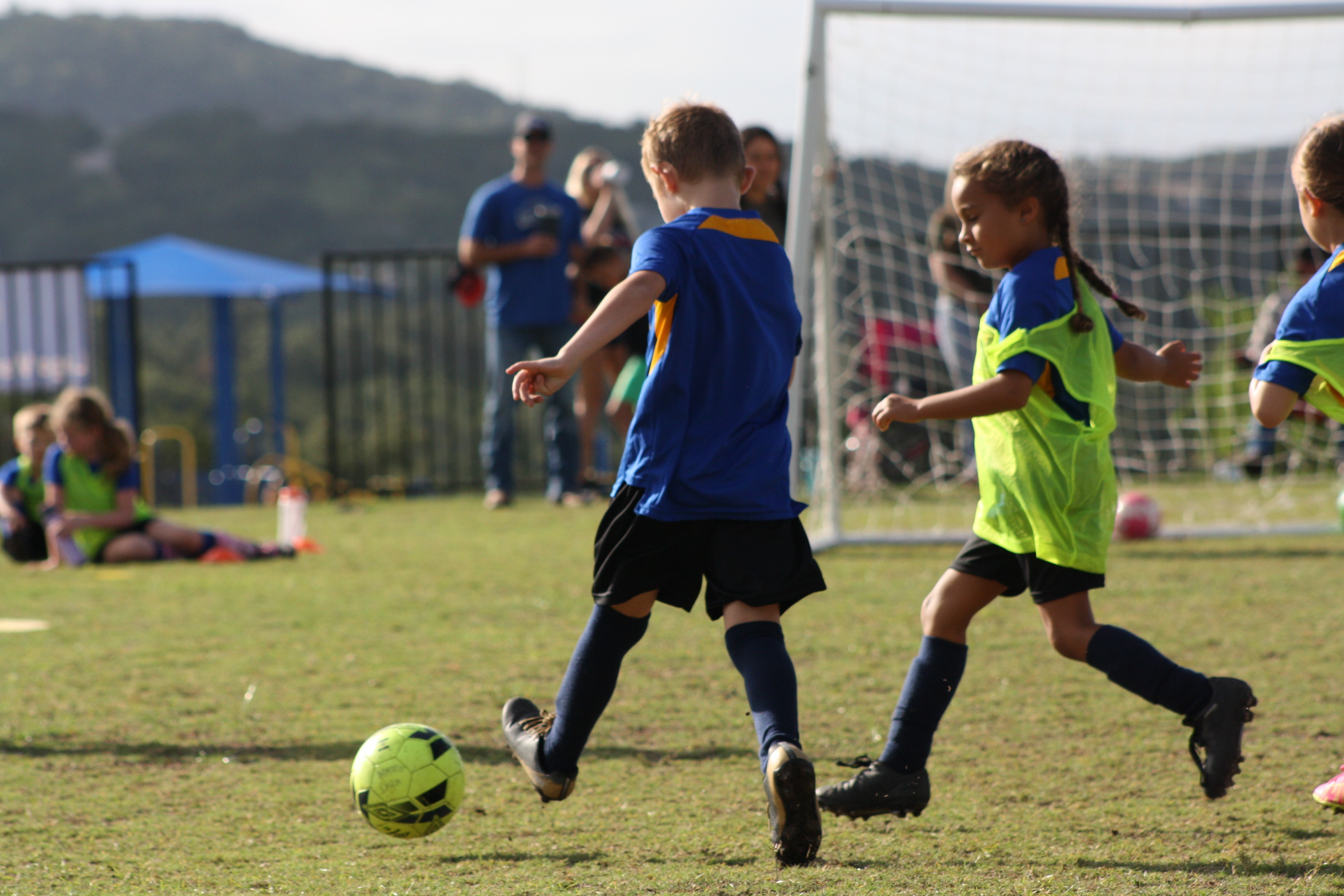 a young boy is jumping in the air on a road