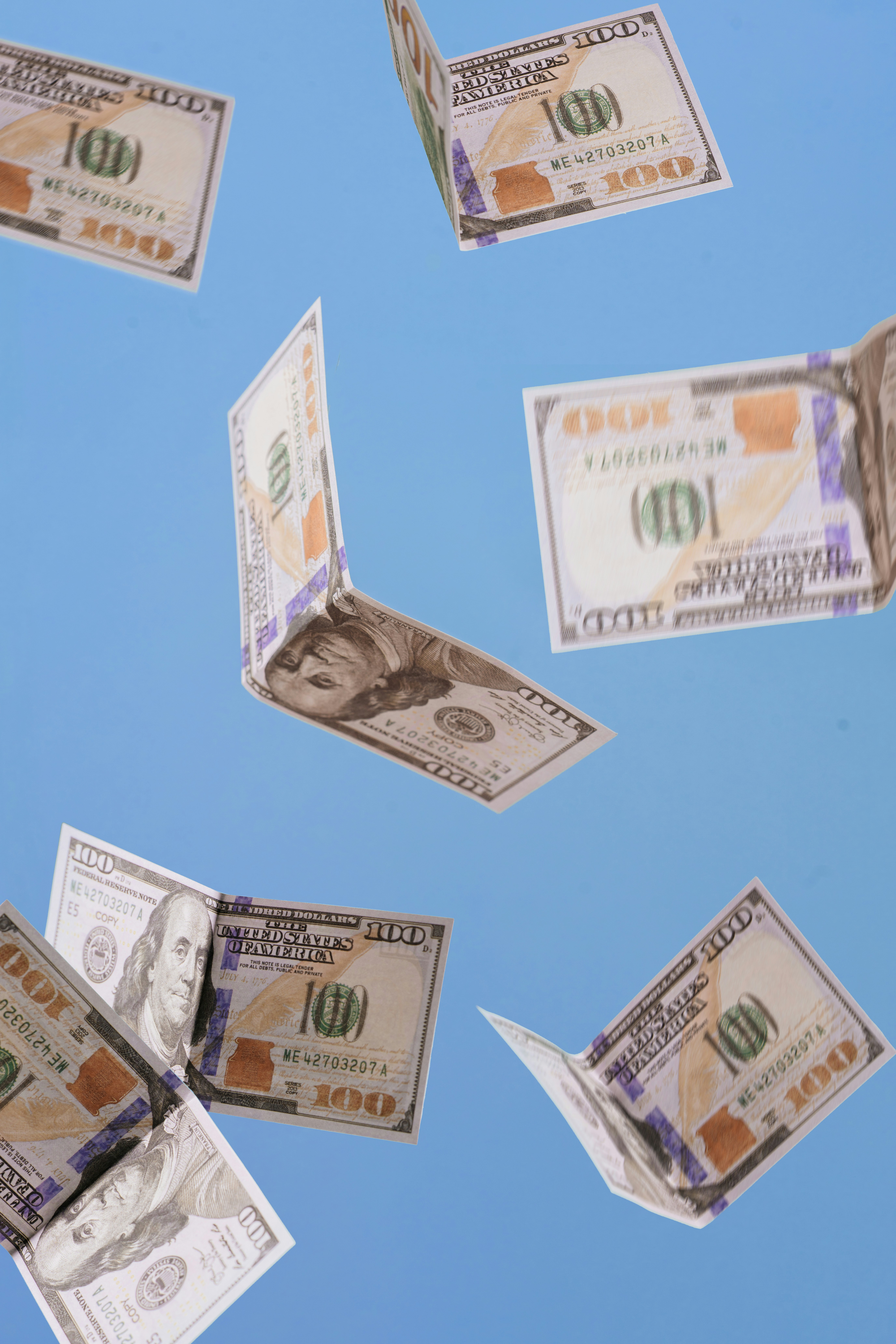 Man sitting on the ground outdoors stretching his leg