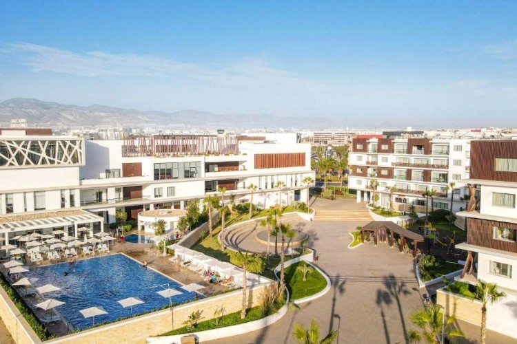 sunloungers fronting buildings near mountain