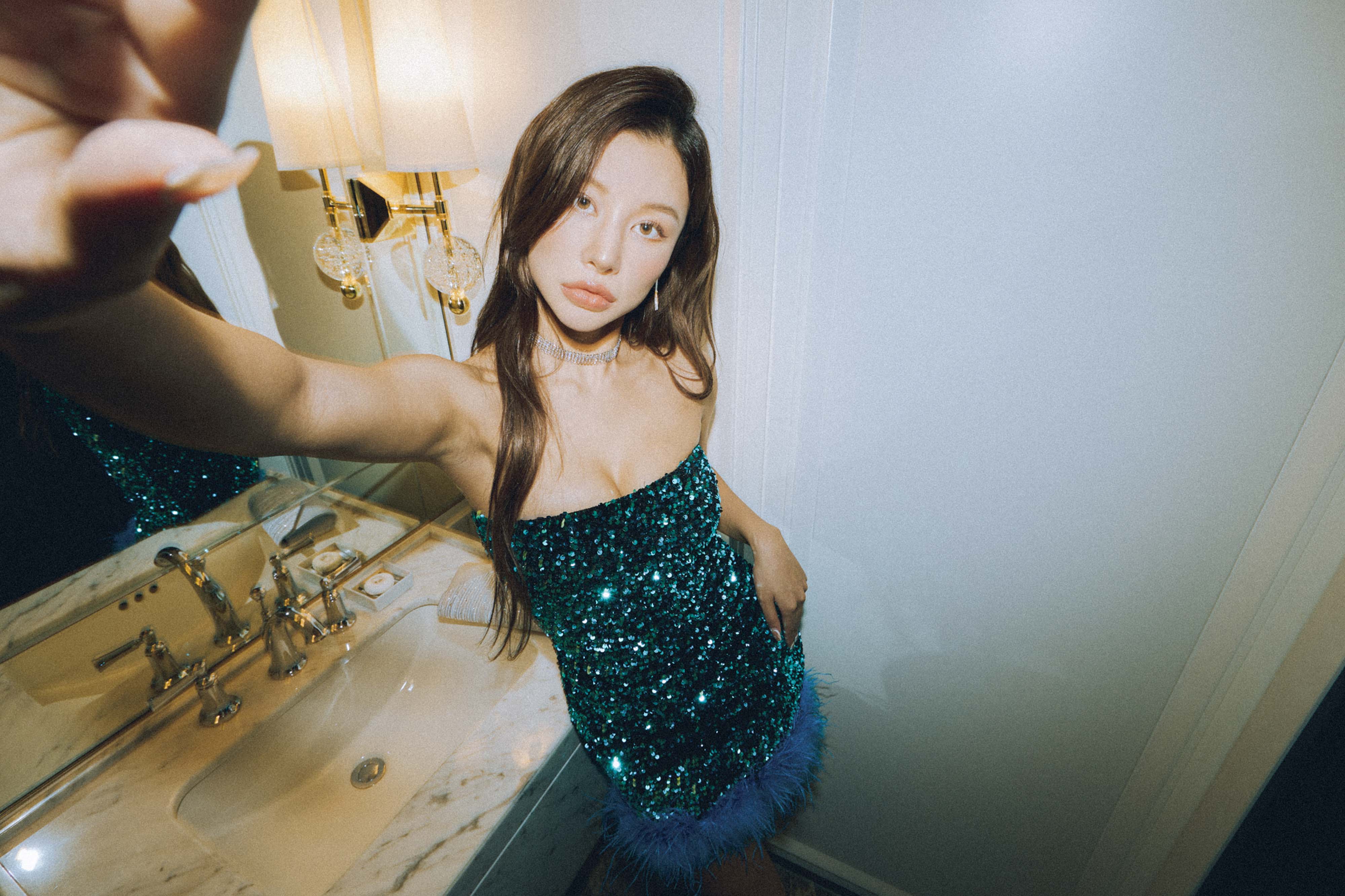 "Glamorous and confident, capturing a moment in emerald sequins."