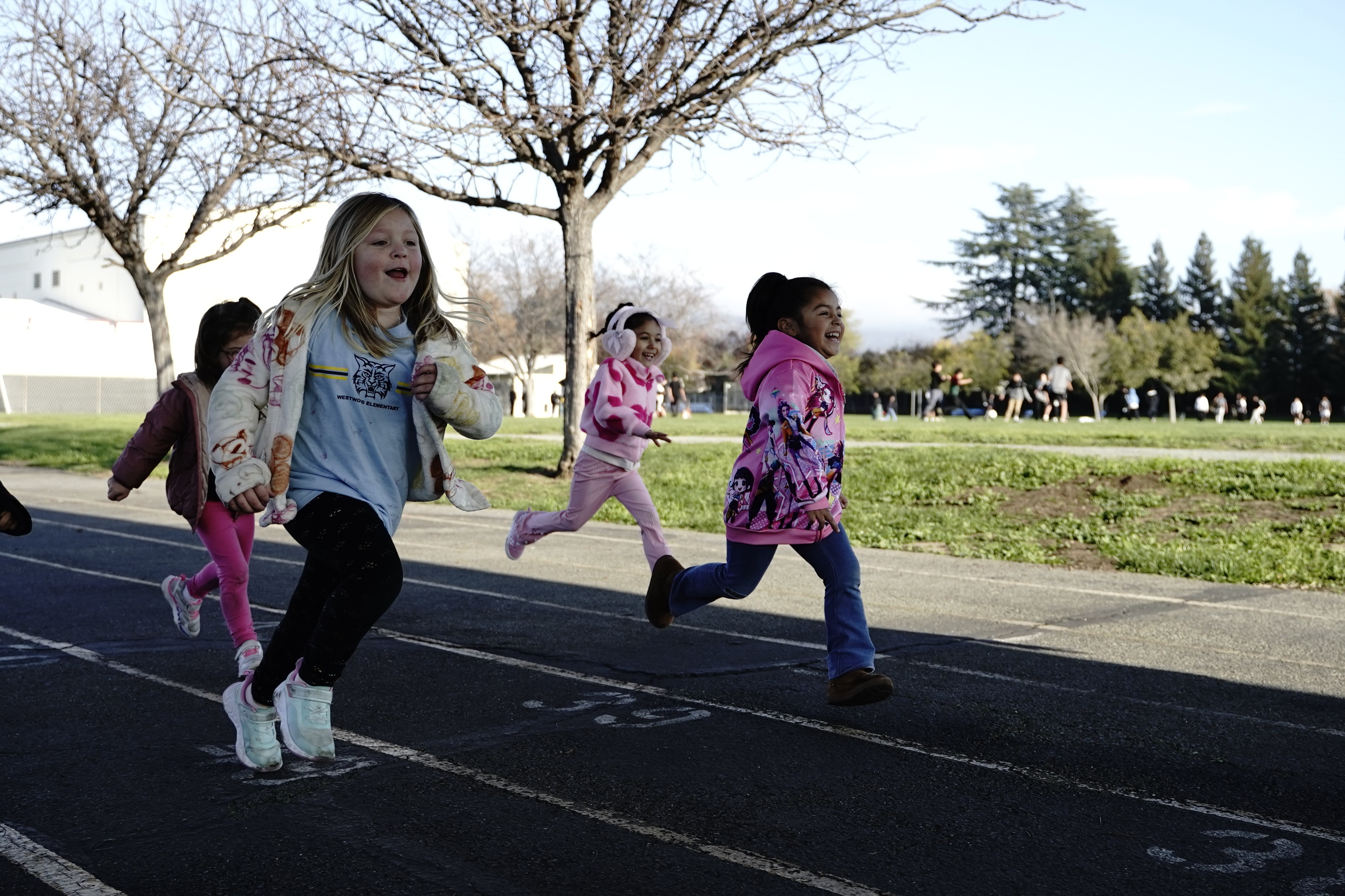kids running and playing outdoors during an aftercare program at an elementary school
