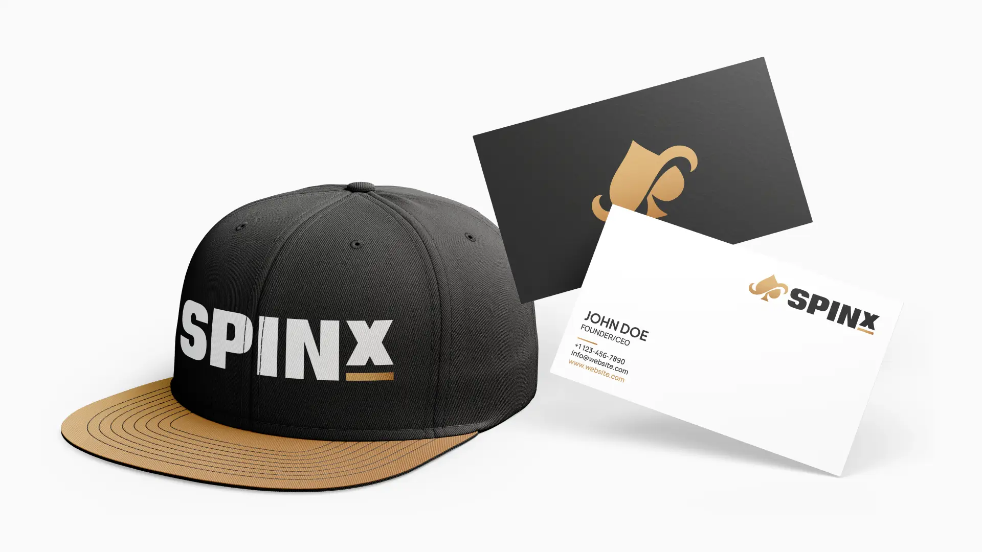 Black and gold cap with "SpinX" logo, paired with matching business cards. The setup conveys a modern, professional brand identity.
