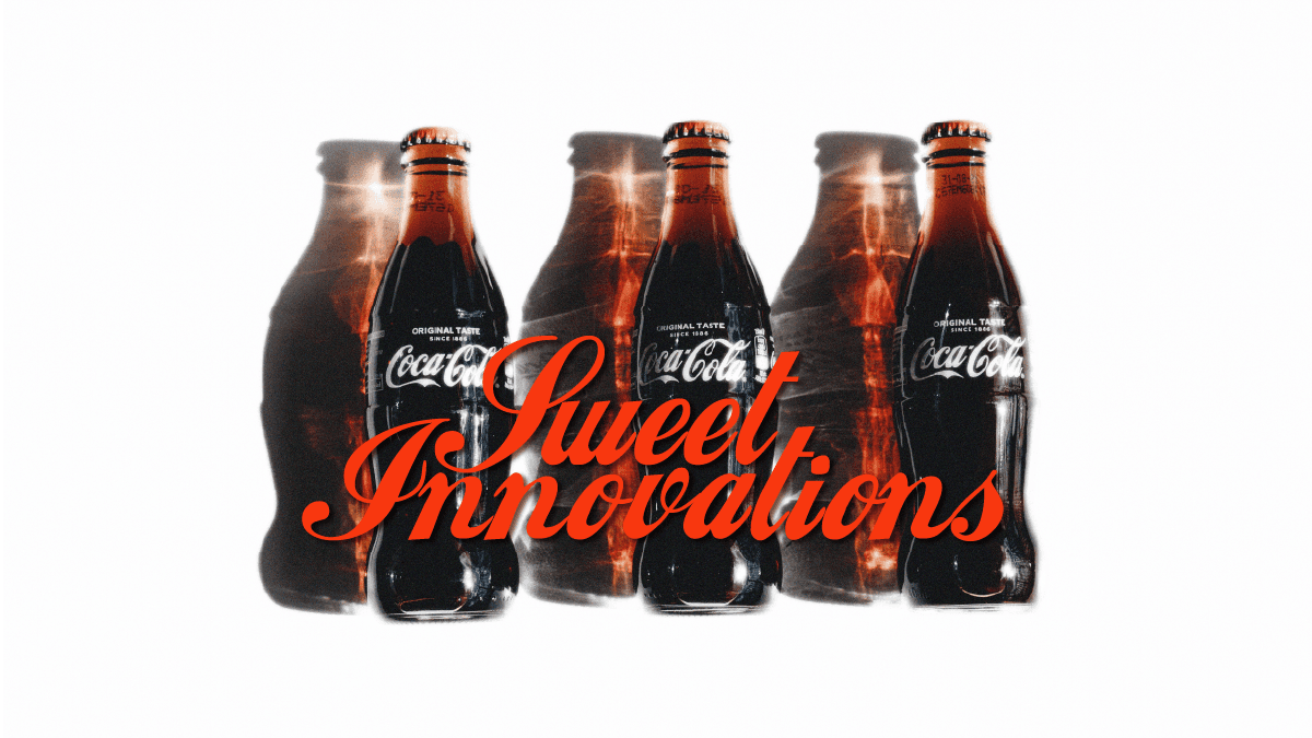 Three glass bottles of a dark soda arranged in a group with an orange label in a white background.