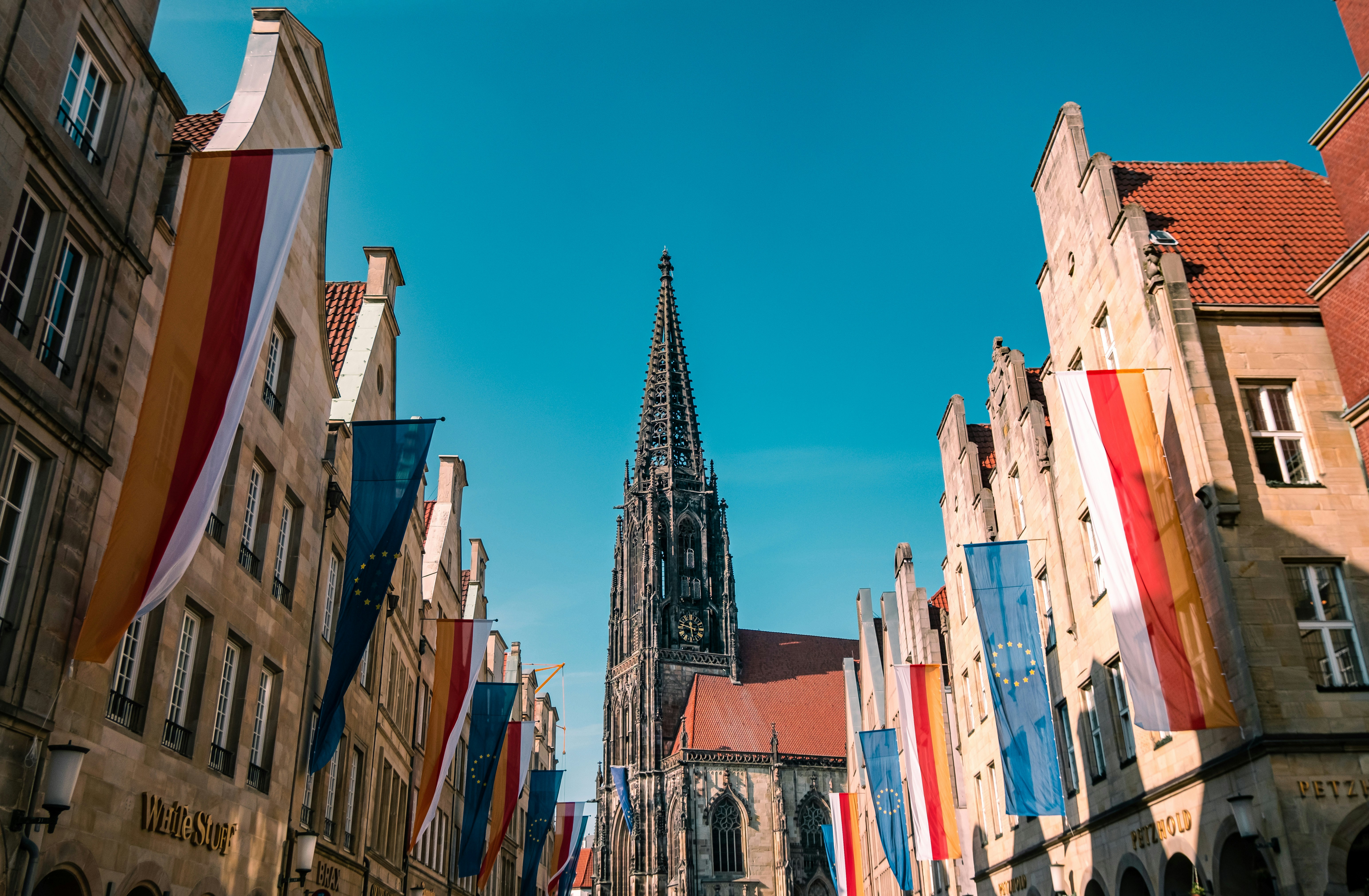 a group of buildings with flags
