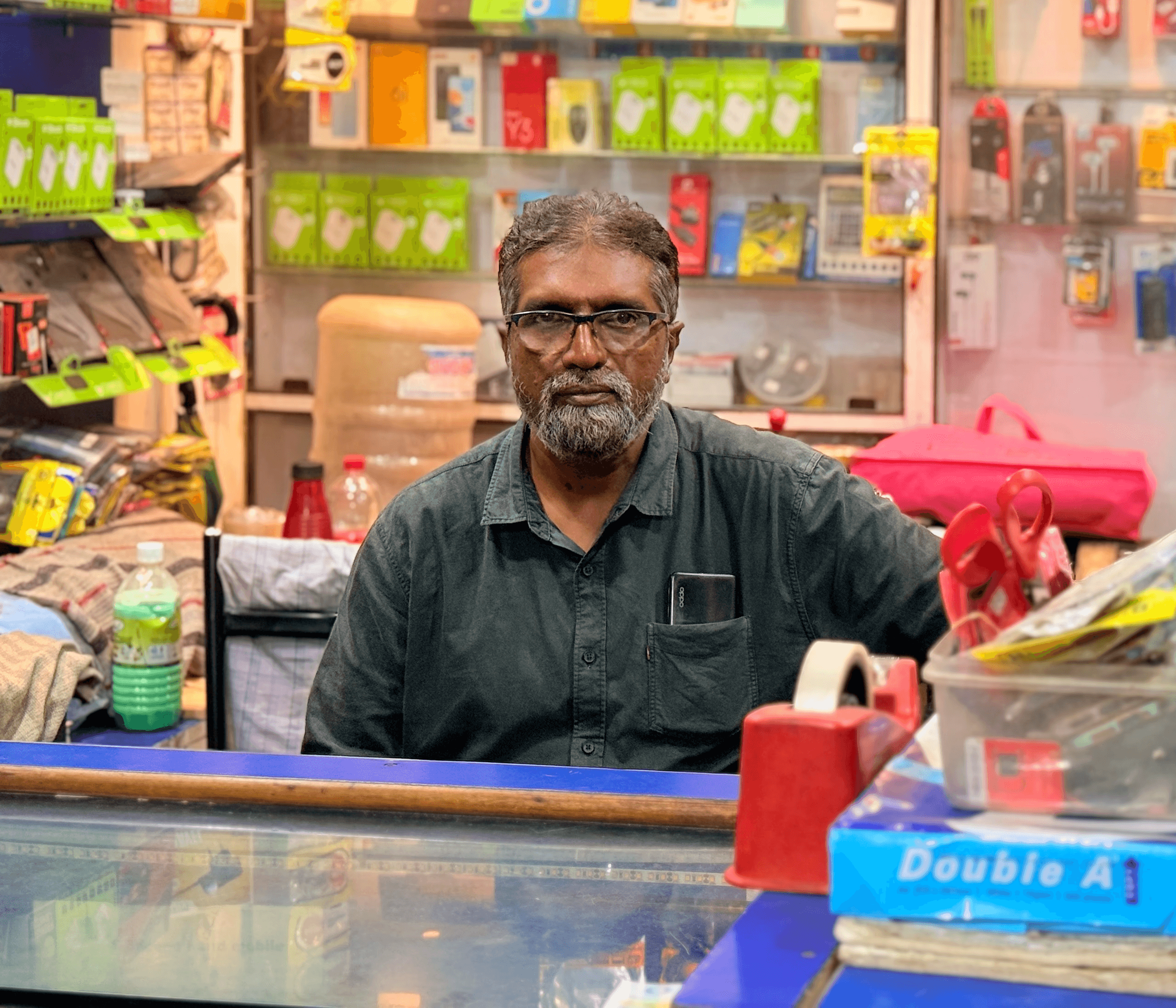 An image of a Shop keeper with his shop