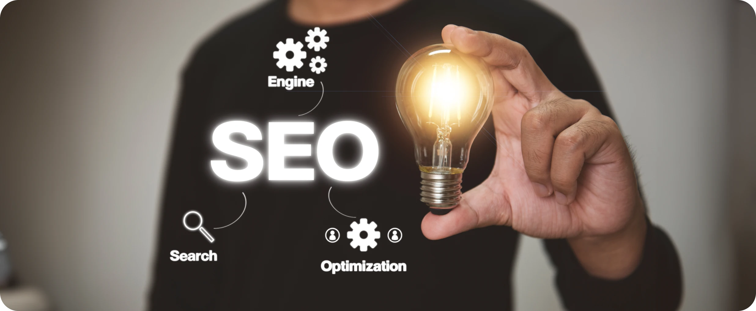 Man holding a light bulb with the words SEO, Optimization, Search, and Engine