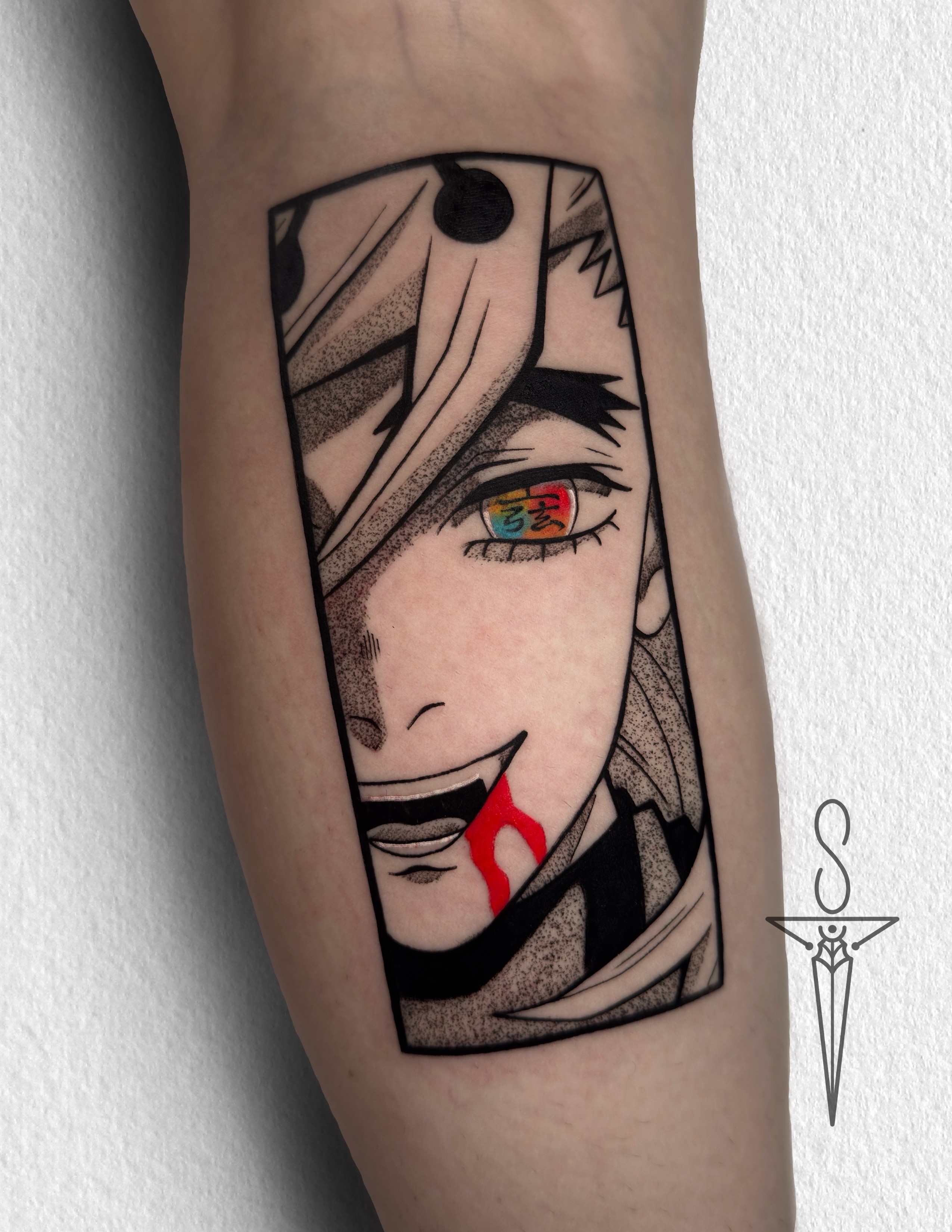 A vibrant tattoo of a chainsaw-like creature on a person's forearm. The tattoo is detailed with shades of orange, black, teal, and red.