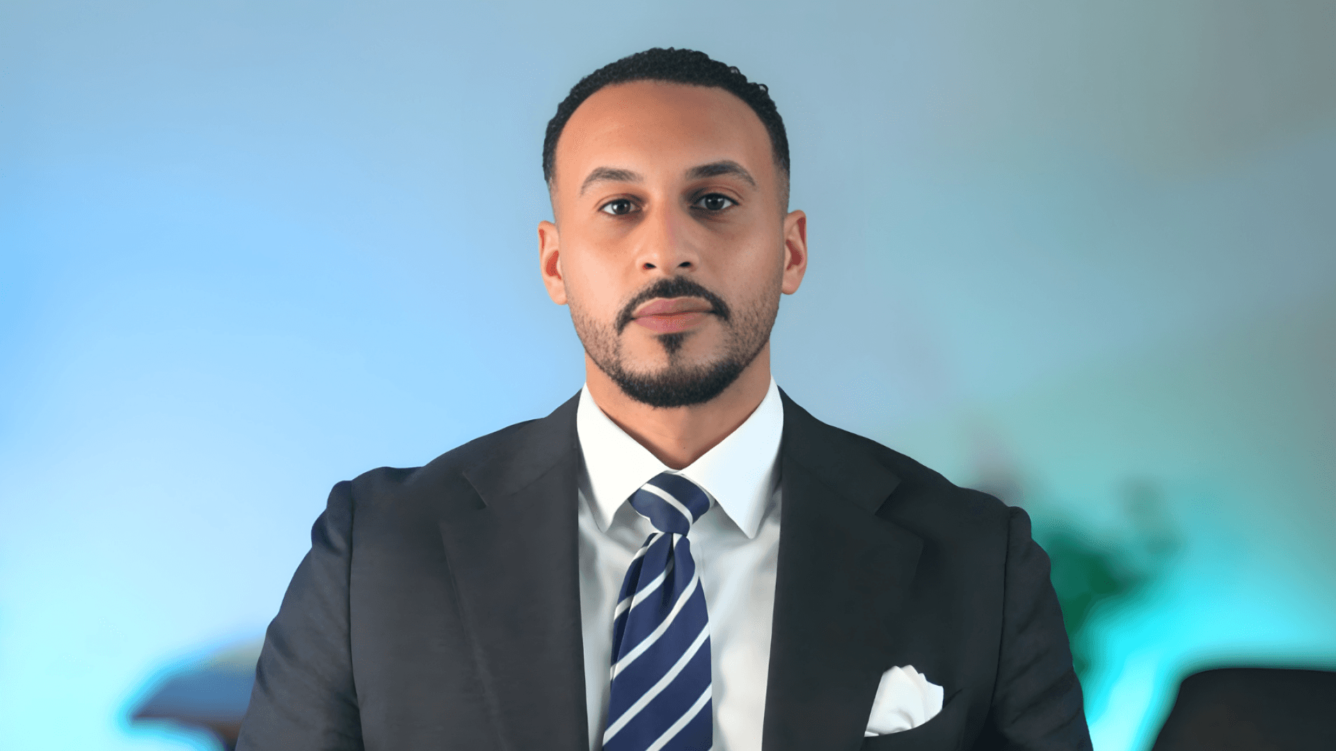 A woman with straight blonde hair wearing a light colored sweater looks away.