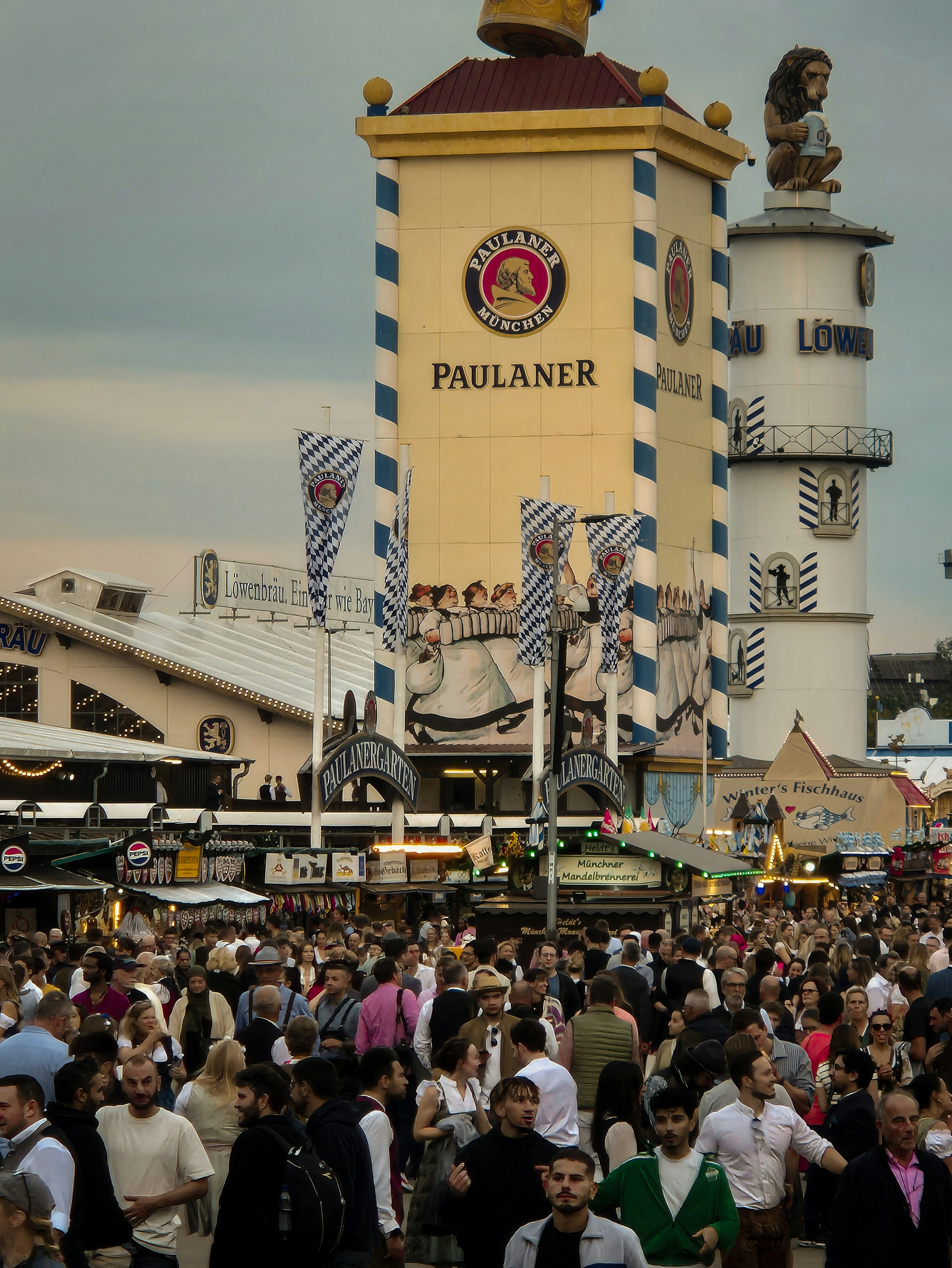 A large crowd of people standing in front of a tall building