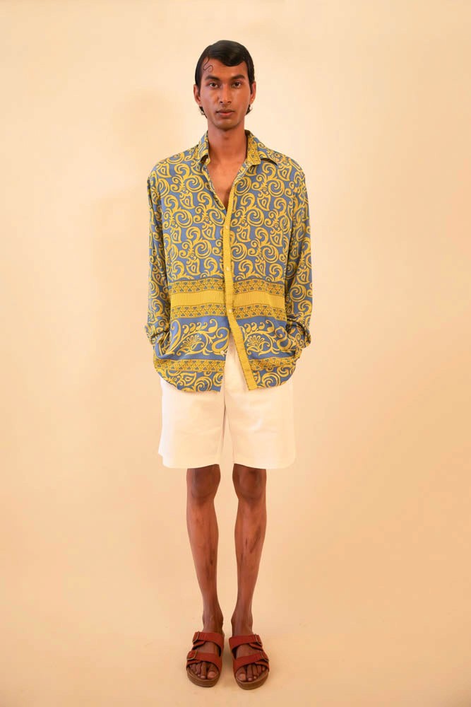 Baroque-printed silk shirt handcrafted from a vintage sari, featuring a relaxed unisex fit, full sleeves, contrast piping, and a soft drape, celebrating slow fashion and timeless craft.