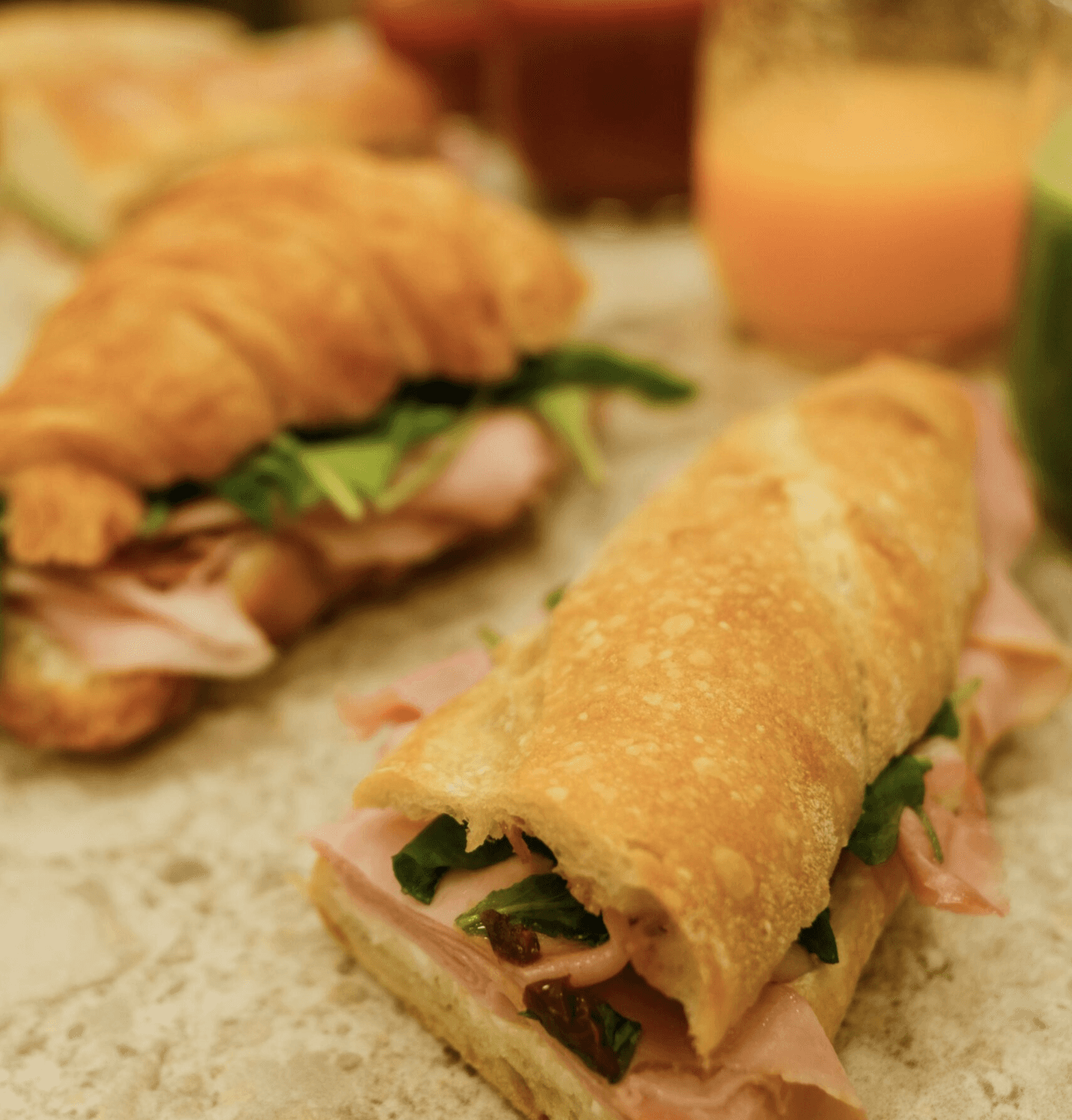 Fresh sourdough baguette sandwich with ham and greens served at Jo & The Sisters Morning Club.