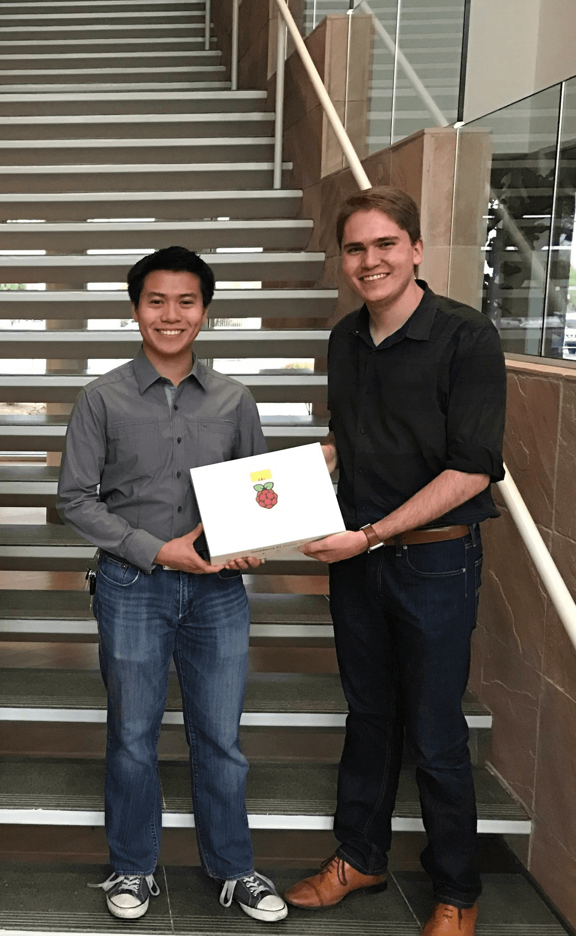 Alex accepting a hackathon prize with his teammates