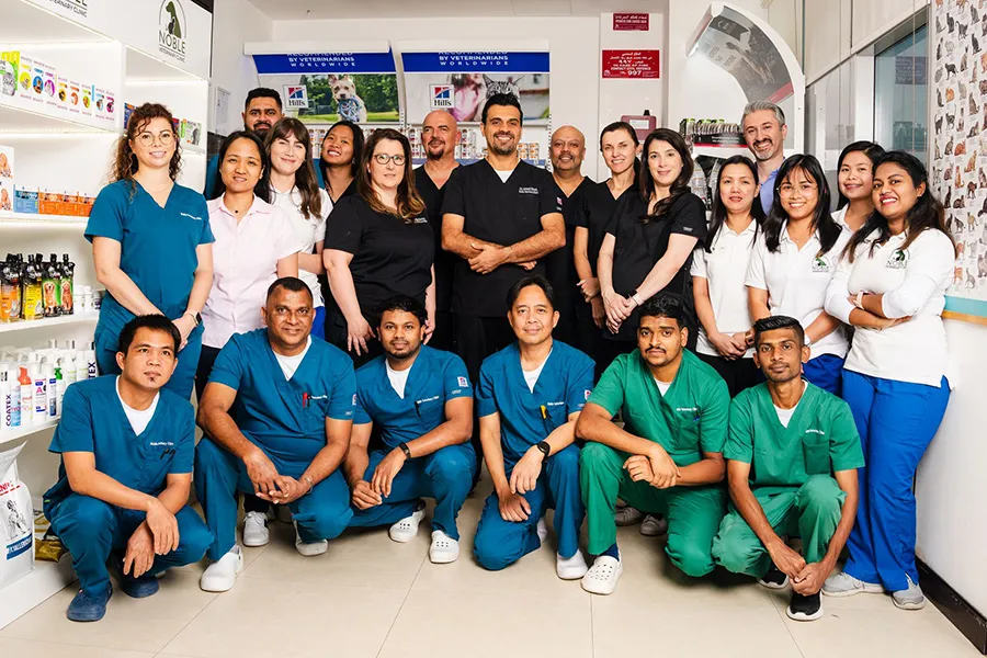 A group ohoto of veterinarians inside a clinic.