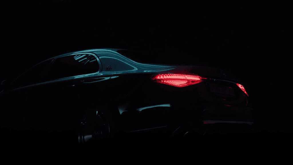 Detail of the Mercedes Maybach catching light reflections in a dark studio.