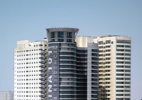 Wide view of Grosvenor Commercial Tower and surrounding urban landscape in a key business district.