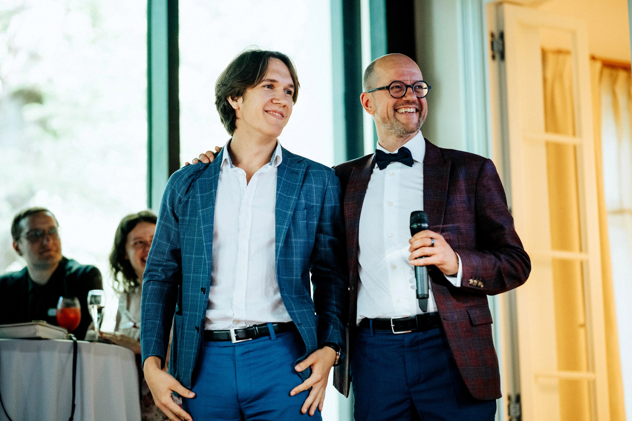 man in white dress shirt sitting beside woman in black long sleeve shirt