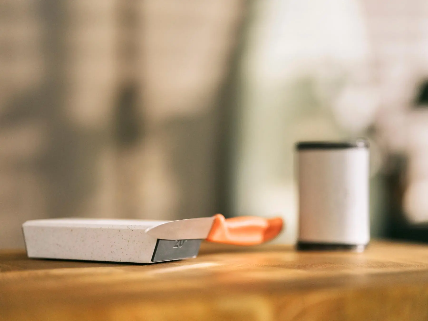 A small kitchen knife securely held by the HORL® Magnetic Angle Support, demonstrating the strength of the Grip Pad magnets in maintaining a stable position during sharpening.